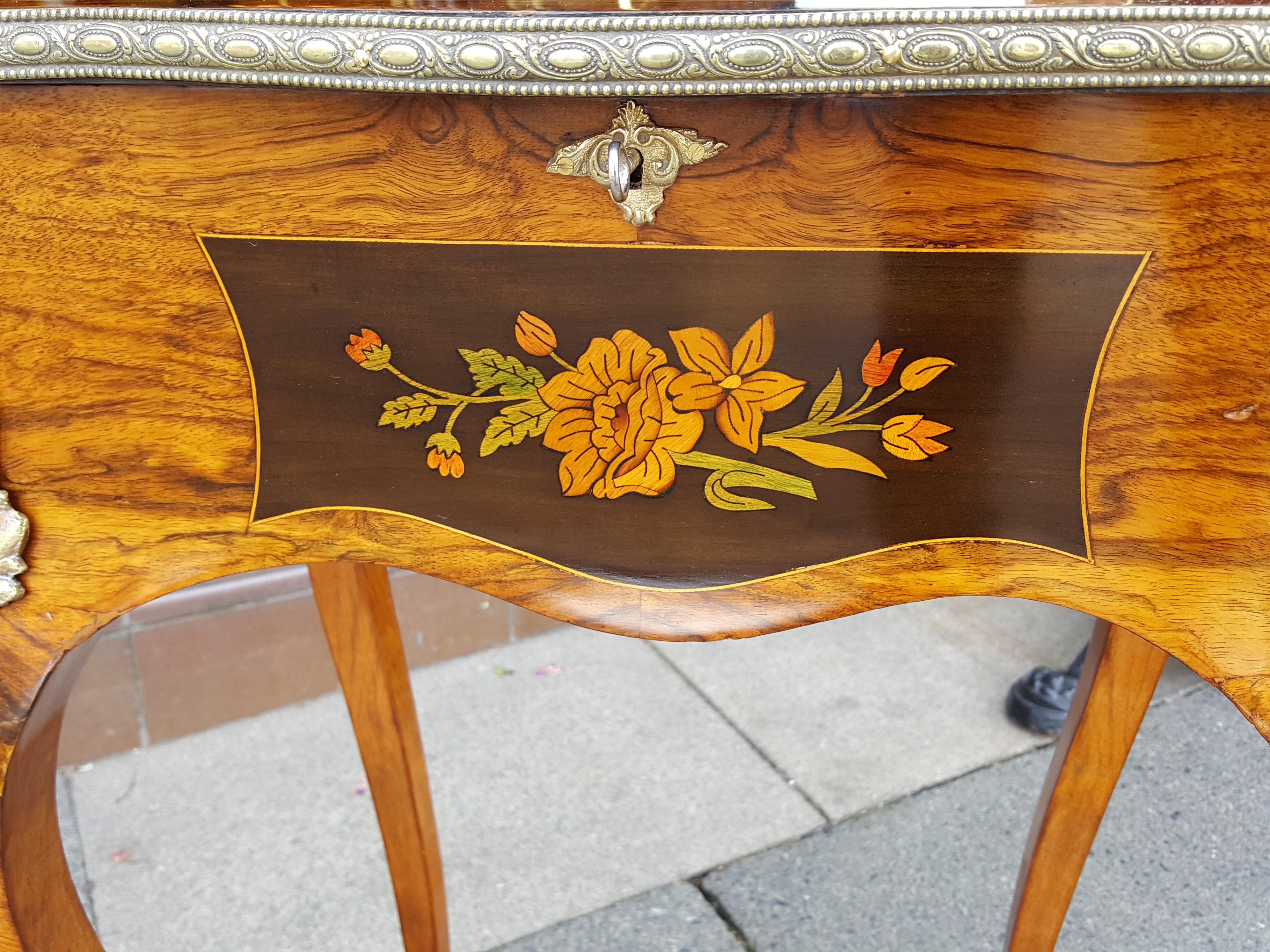 Victorian walnut floral marquetry teapoy, of serpentine outline, the top opening to an interior with two lidded compartments and centre aperture, raised on cabriole legs terminating in sabot feet 19