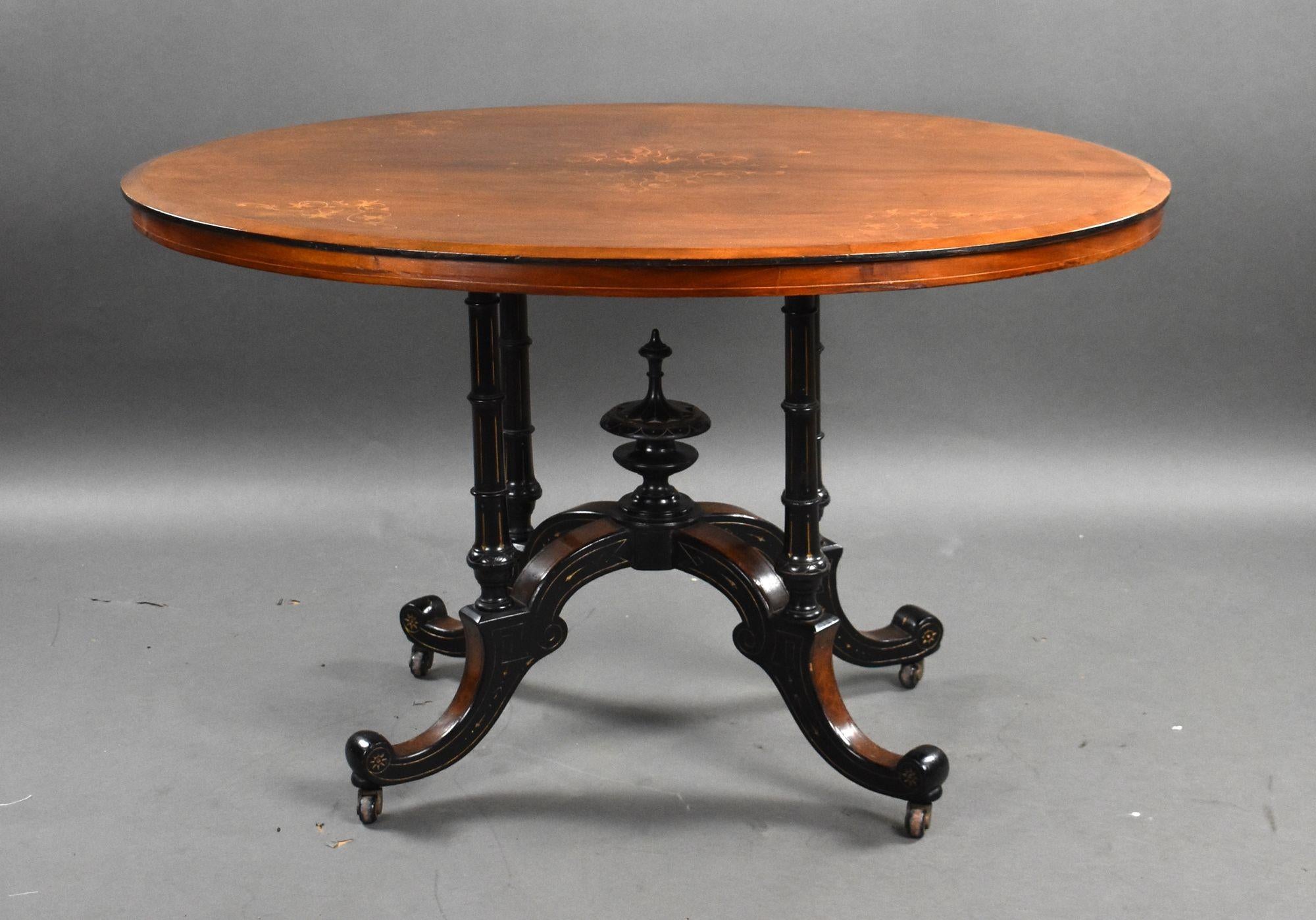 For sale is a good quality Victorian walnut inlaid oval centre table, the top raised on a birdcage base with ornate finial to the centre, with gilt detailing, raised on castors, this table remains in good condition, showing minor signs of wear