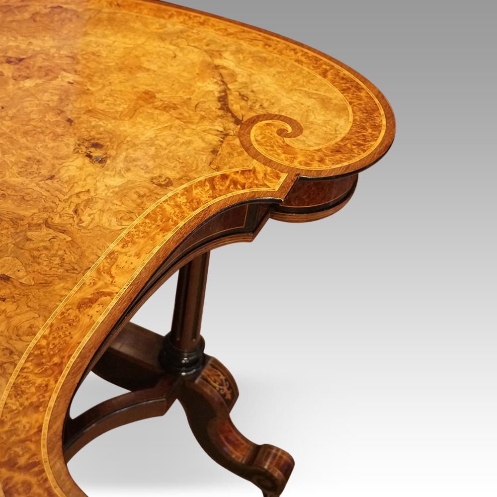 Victorian walnut kidney writing table 
This Victorian walnut kidney writing table was made circa 1870.
It is of a dramatic kidney shape with the top in burr walnut and a good deep thuya wood banding and purple heart running around the edge. 
The