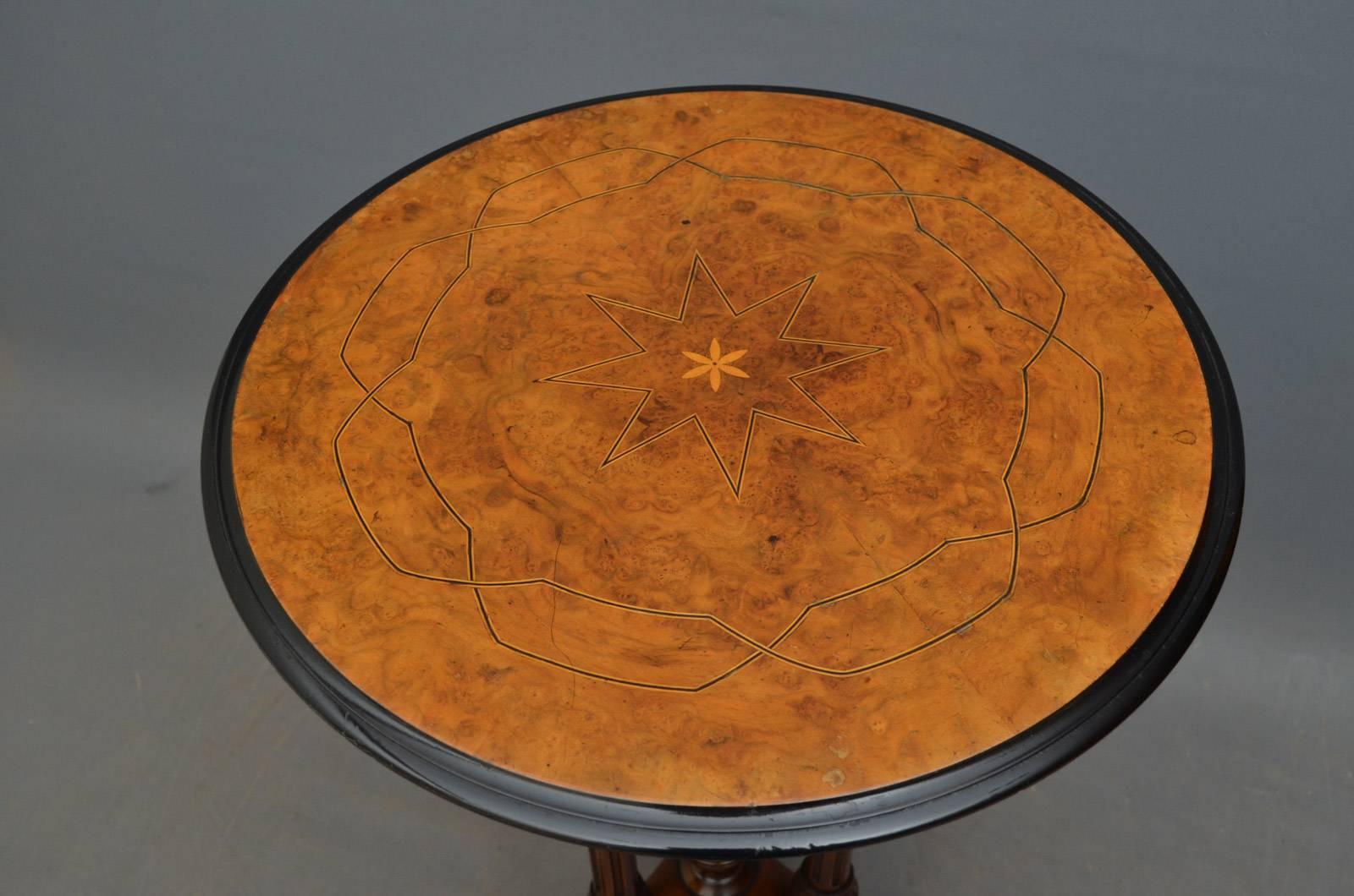 Sn4291, fine quality Victorian occasional table, having burr walnut top with string inlaid decoration, moulded and ebonised edge and 3 turned, reeded and carved legs terminating in carved and downswept feet. This antique table retains its original