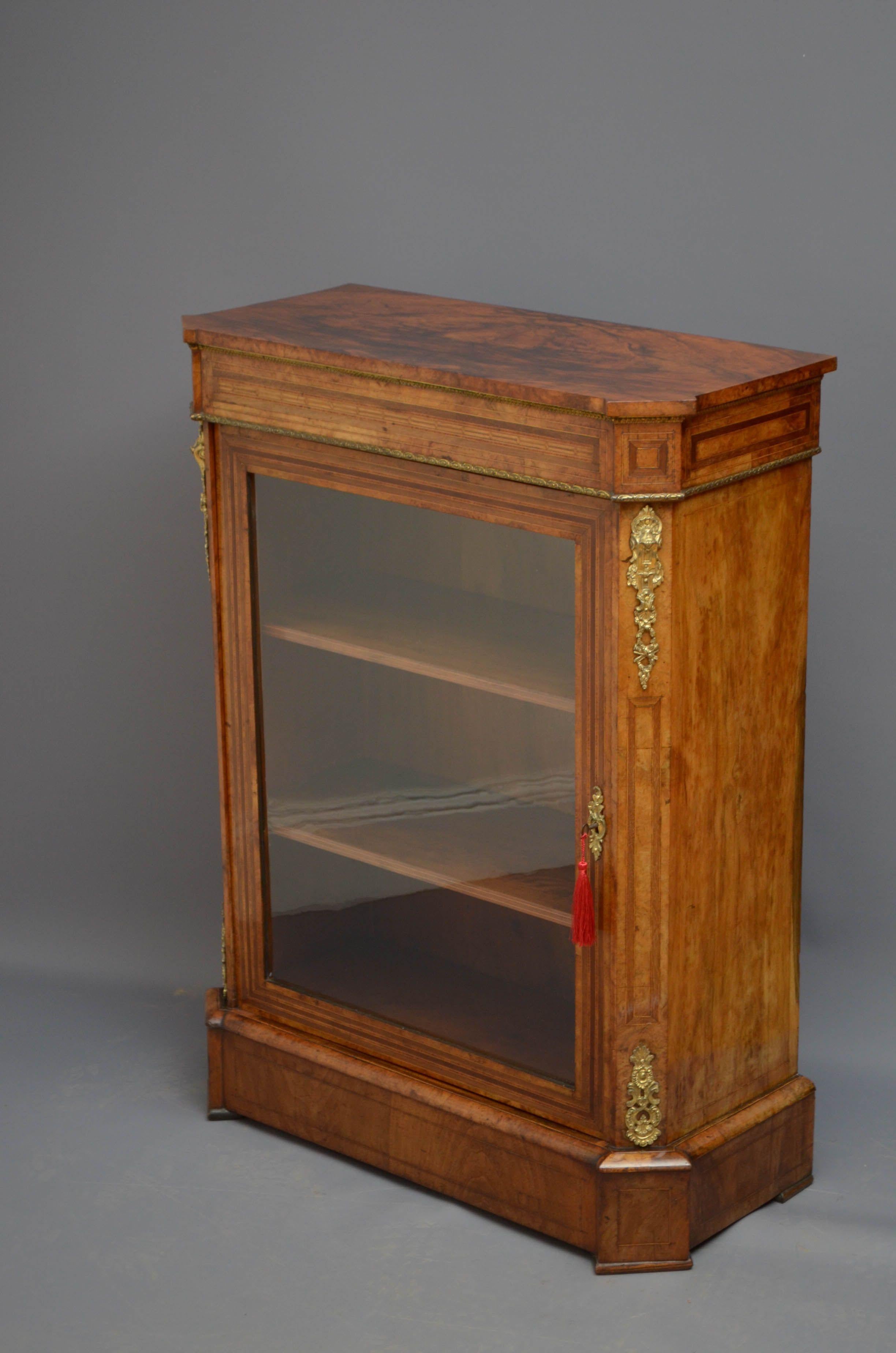 Sn5161 Victorian, walnut, pier cabinet, having figured walnut, moulded top, inlaid and crossbanded frieze above satinwood string inlaid and banded glazed door fitted with working lock and a key and enclosing 2 shelves flanked by fine quality ormolu