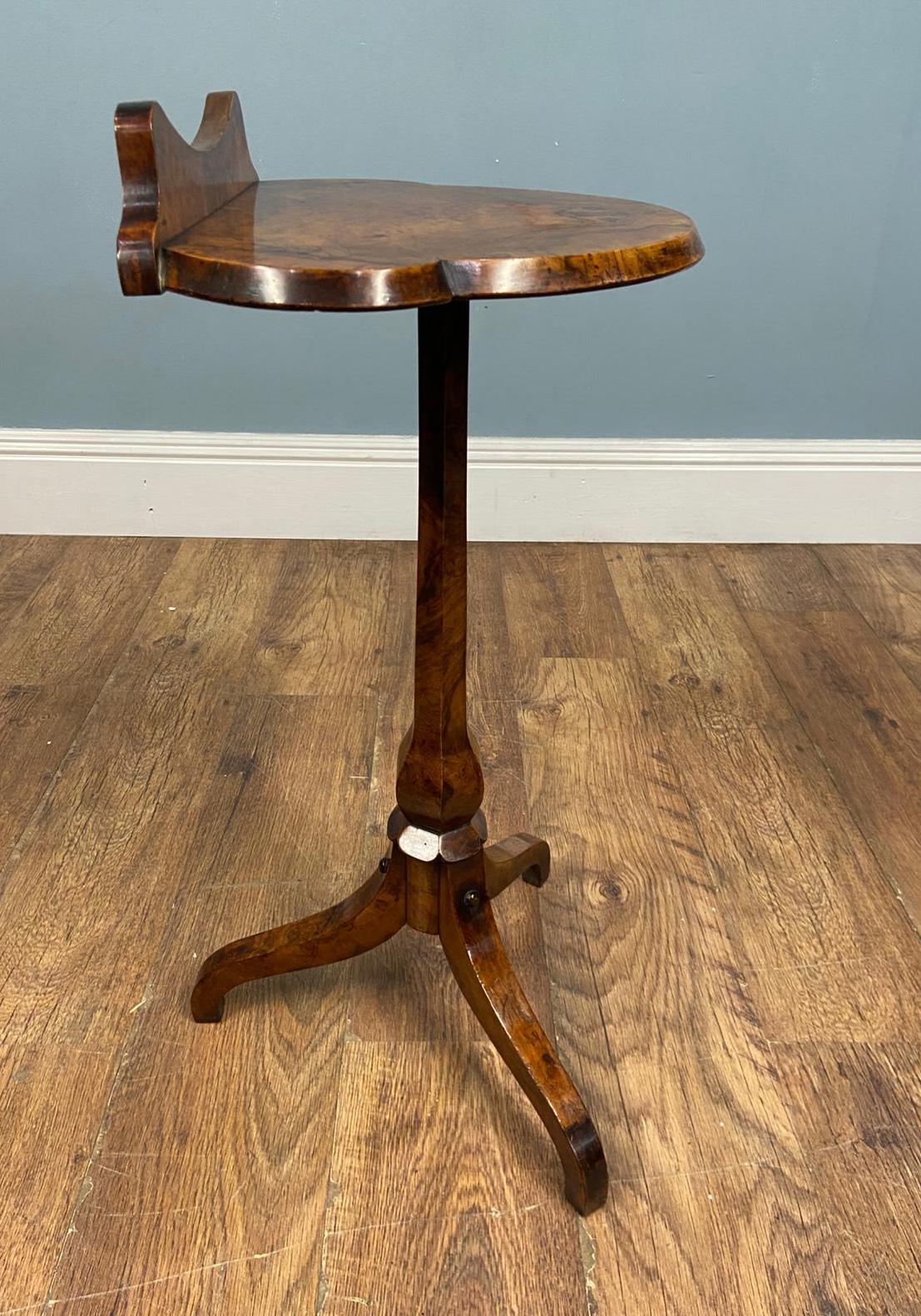 You are viewing a dainty Victorian tripod side or wine table
Circa 1880
A very attractive burr walnut tripod side table, full of warmth and character
The top is shaped with gentle undulating curves and features a small raised back gallery, giving it