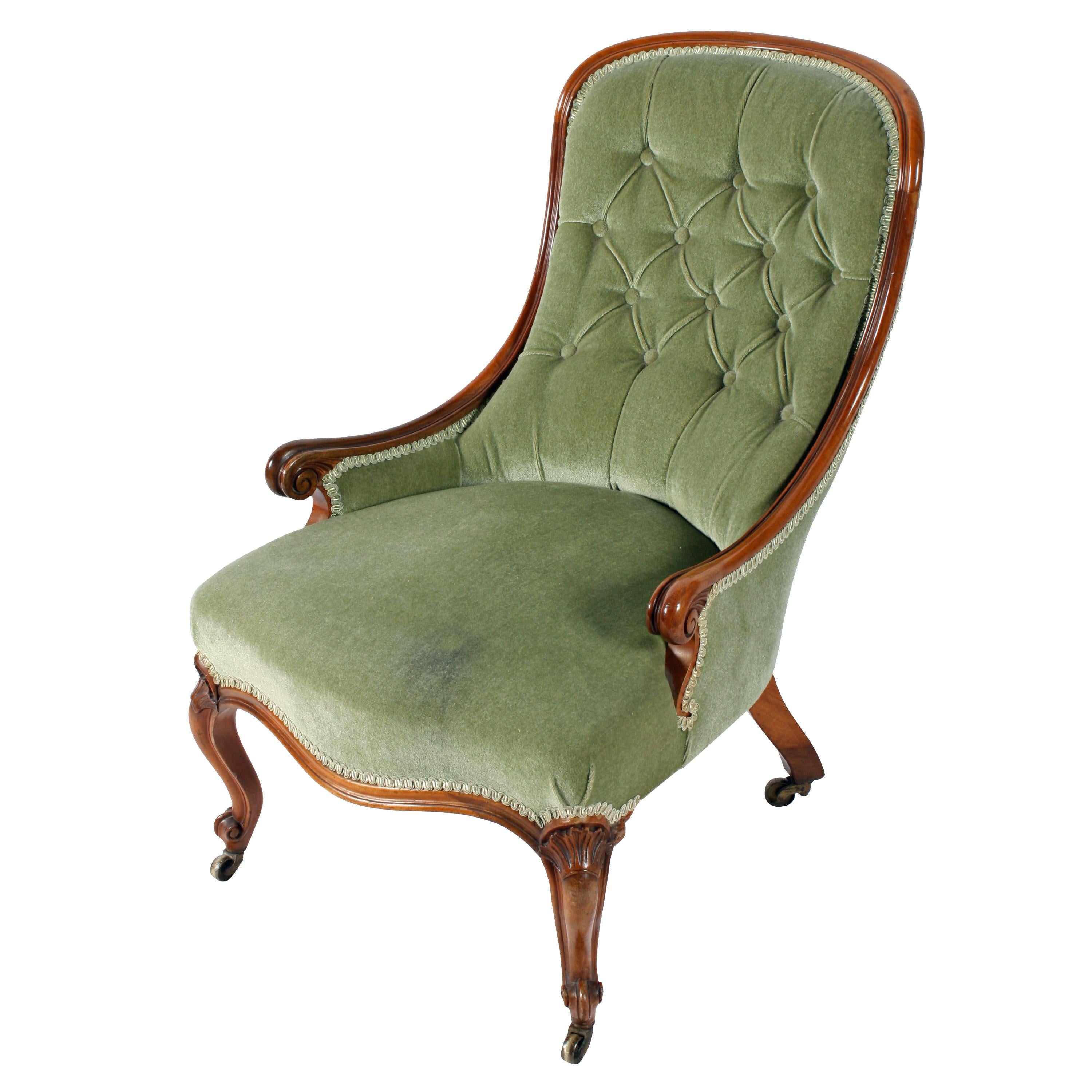 A fine quality 19th century Victorian walnut slipper shaped easy chair.

The chair has a molded walnut frame with low arms that end in a scroll.

The chair has a serpentine shaped front with cabriole legs that have scroll toes and carved