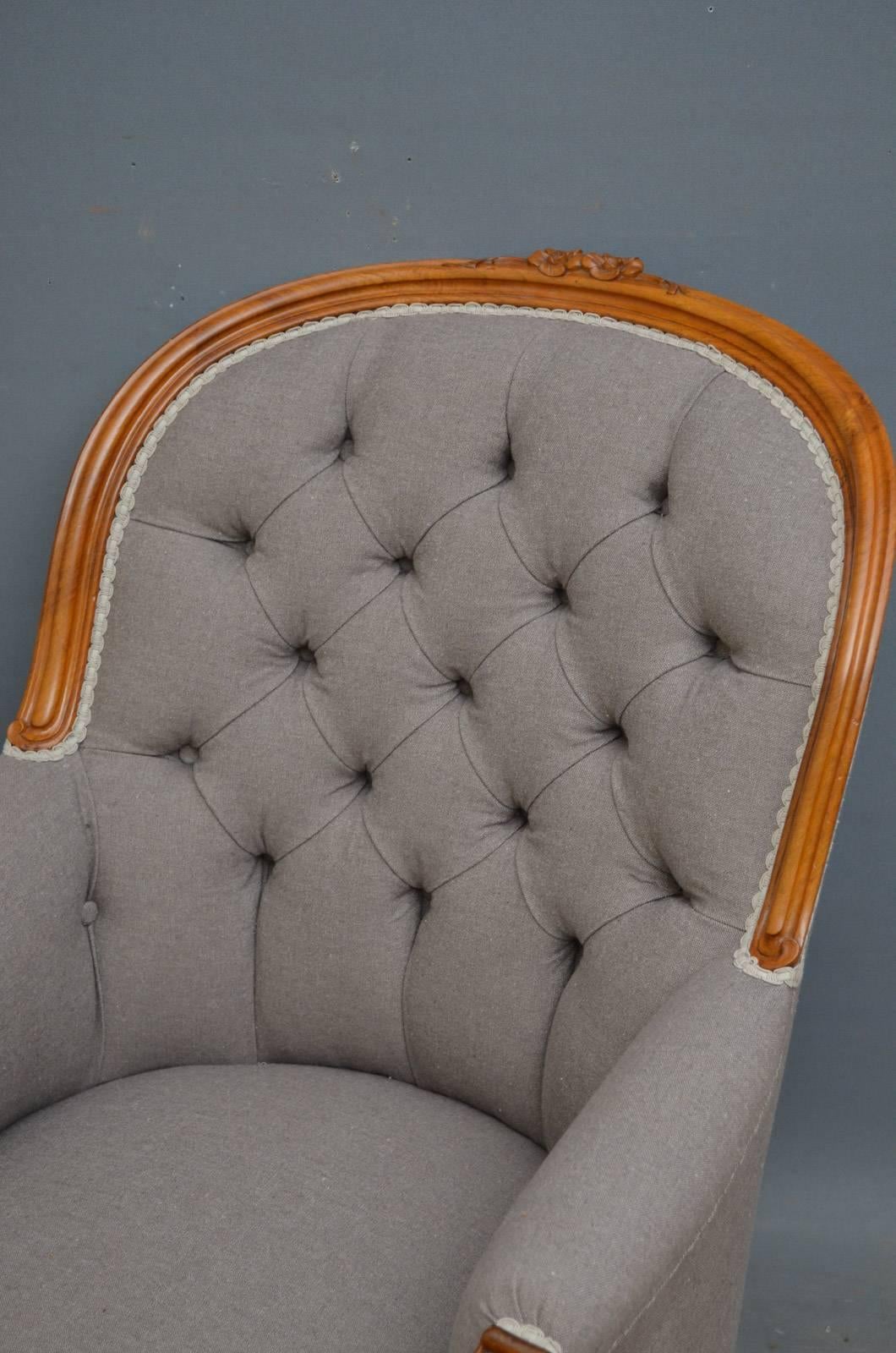 Sn2939 Victorian walnut armchair, having moulded frame with floral carving to centre, buttoned back and generous seat with carving to centre, flanked by carved knurl arms and cabriole legs, standing on original brass castors. This antique armchair