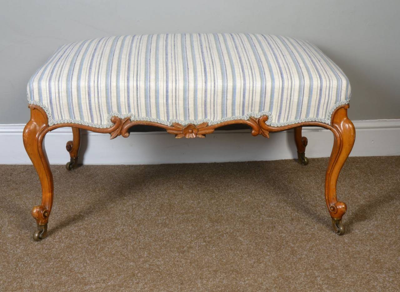 large walnut stool the upholstered stuff-over seat above scroll-carved seat rails, raised on four cabriole supports terminating in scroll feet with castors
Dimensions:
Height 20 inches
Width 36 inches
Depth 27 inches.