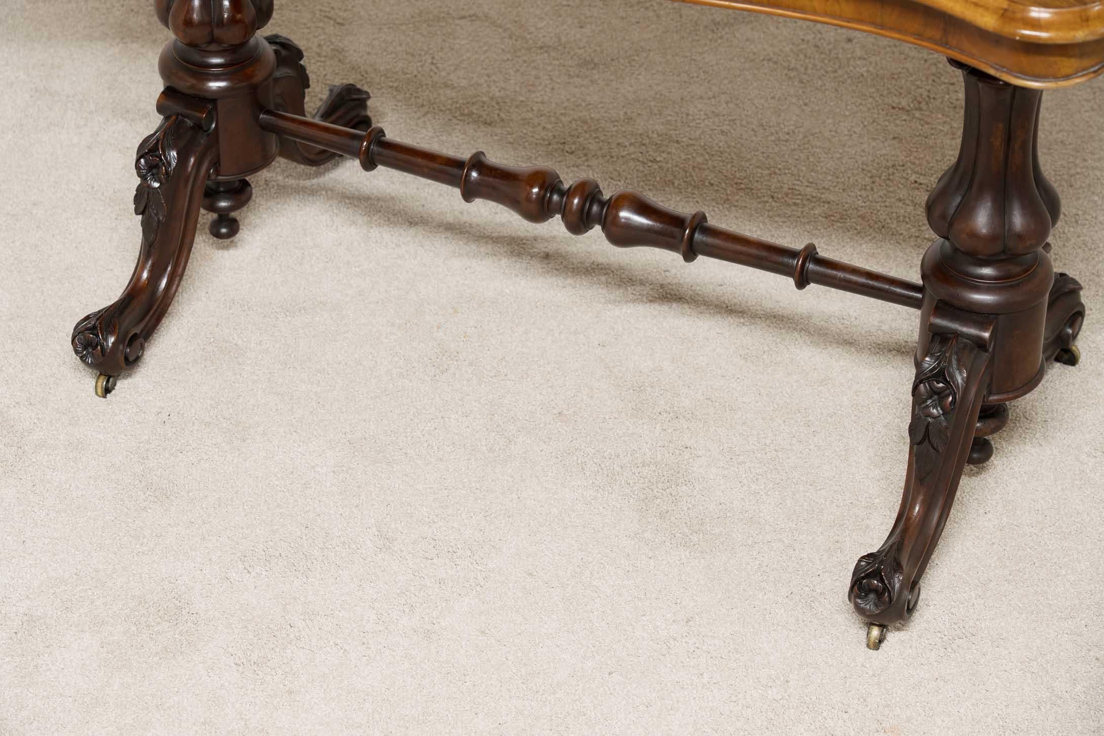Elegant Victorian stretcher - or side - table
Hand crafted from walnut and we date this to circa 1880
Elegant shape to the table top and carved feet
Look at the sumptuous patina to the burr walnut
Offered in great condition, ready for home use and