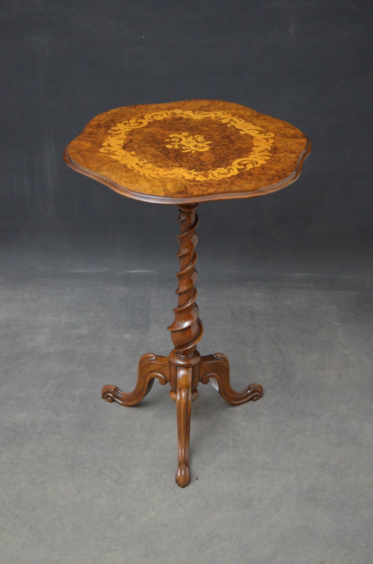 Sn4826 Victorian burr walnut occasional table, having serpentine top with satinwood floral motifs raised on turned and twisted column ruminating in 3 carved cabriole legs. This antique table has been sympathetically restored and is ready to place at
