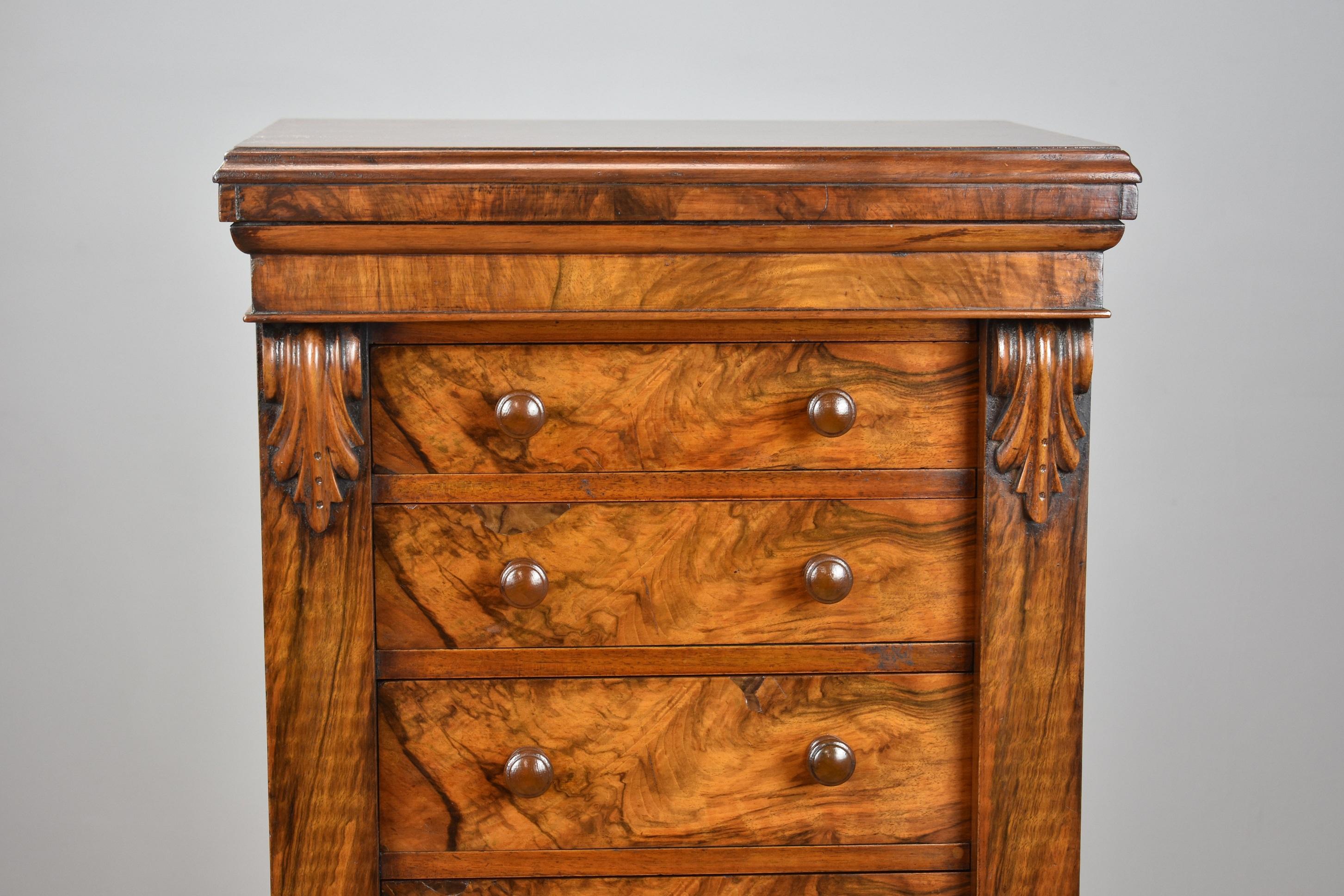 Victorian walnut wellington chest in very nice condition having been polished by hand, the chest has leaf carvings to the top and seven graduated drawers which all lock when the side panel is closed, the chest stands on a plinth base. Complete with