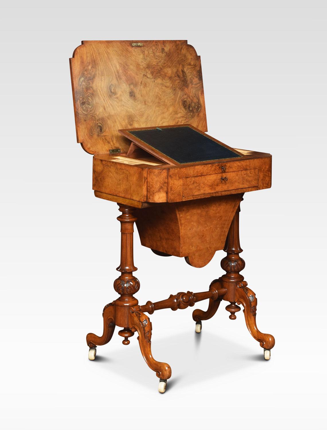 Walnut work table, the rectangular-shaped burr walnut lifts up top, opening to reveal a green leather writing slope and fitted interior above frieze drawer and storage compartment below, raised on carved tapered uprights united by a turned stretcher