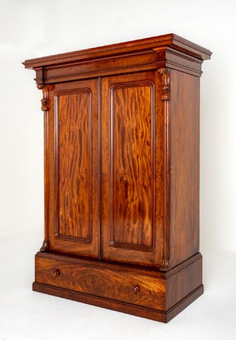 This Wardrobe Stands Upon a Plinth Base.
Circa 1860
The Wardrobe Features 1 Lower Drawer with Turned Knobs.
The Drawer and Door Panels Having Wonderful Flame Mahogany Timbers.
The Doors Being Flanked By Carved Corbels.
The Interior of the Wardrobe