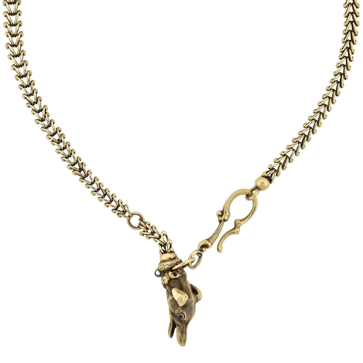 A unique and charming fob watch chain from the Victorian (ca1880) era! Crafted in 14kt yellow gold, this gorgeous pieces features a wonderful 3-dimensional fob that hangs from the end of an ornate chain. The highly detailed figural fob depicts the