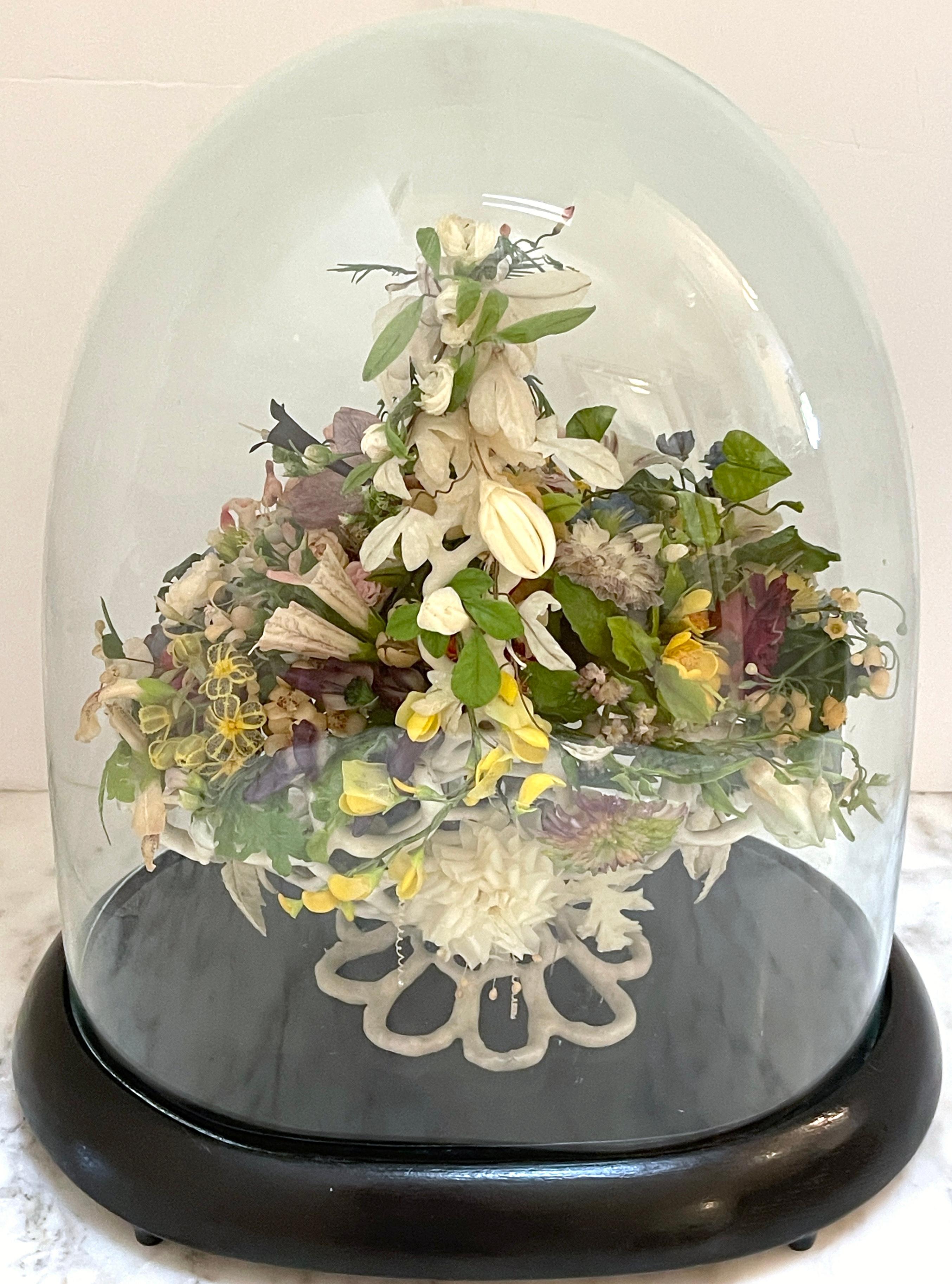 Victorian Wax Flower Basket Still Life  Under Oval Glass Dome
USA, Circa 1880 

An exquisite testament to Victorian artistry: a stunning wax flower Basket still life originating from the USA, circa 1880. This exceptional piece stands encased within