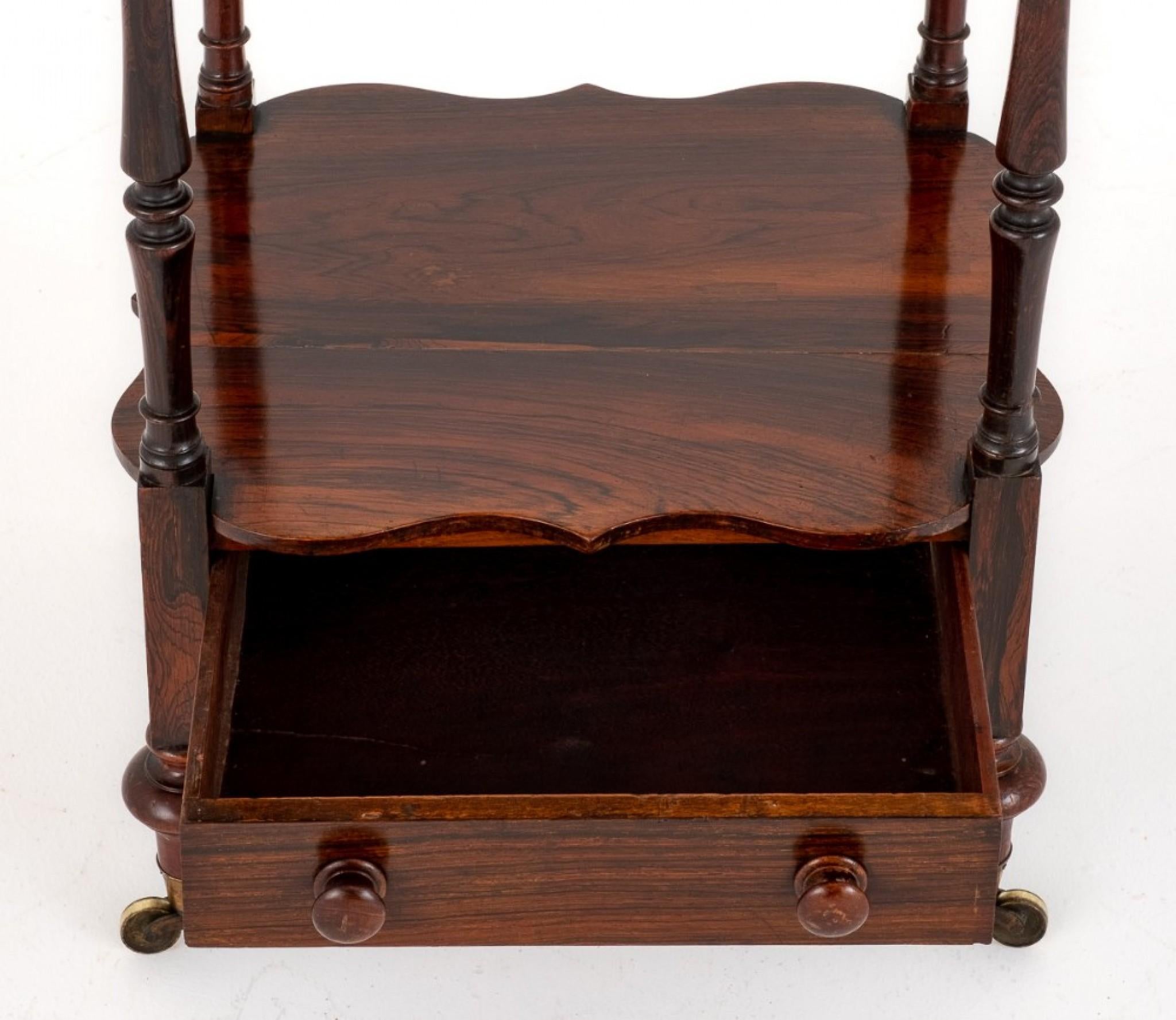 Early Victorian rosewood whatnot.
circa 1850
This quality whatnot stands upon turned feet with original castors.
Featuring 1 mahogany lined drawer, 3 shaped shelves and turned supports.
The whatnot is finished with turned finials.
Presented in