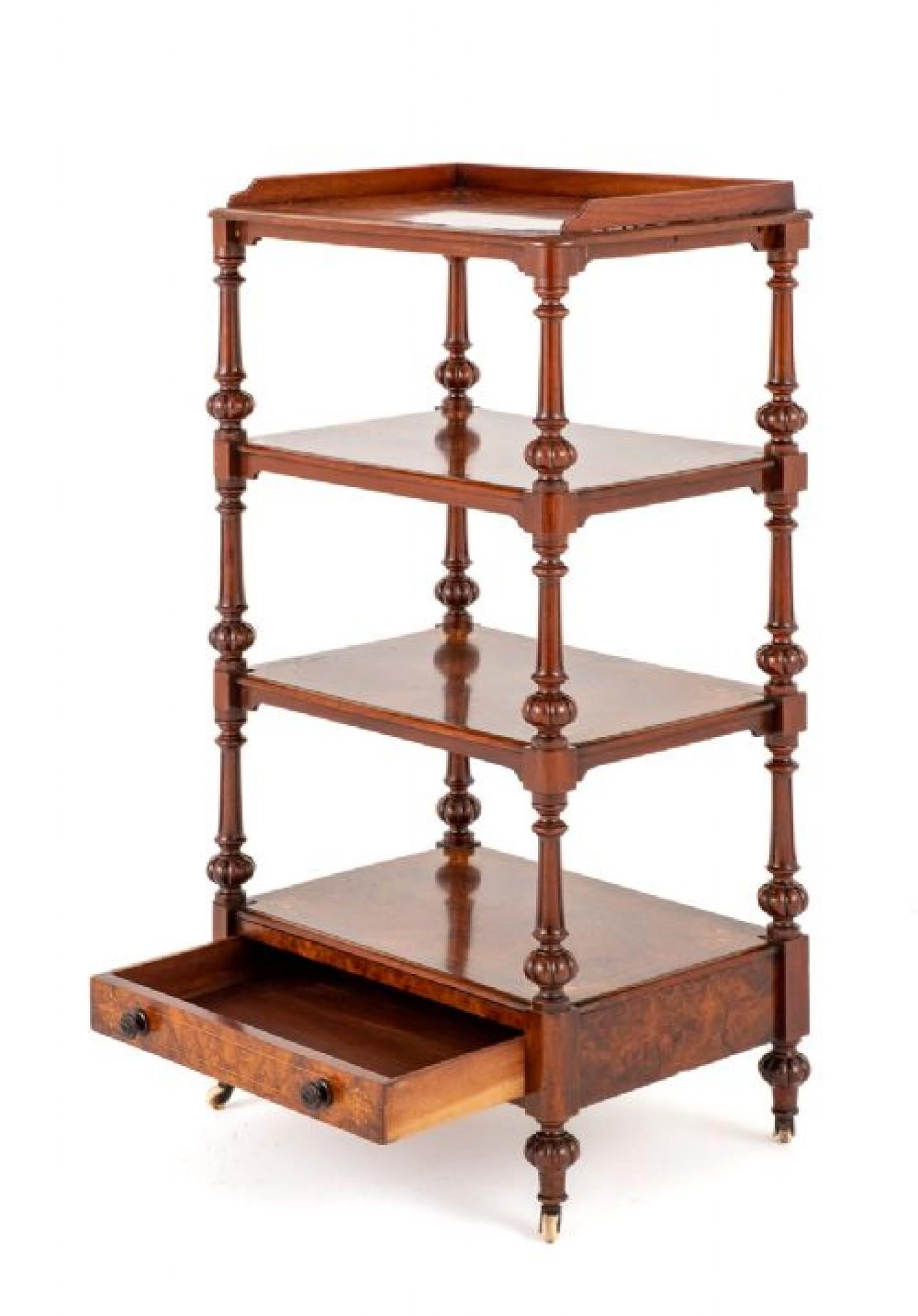 This high-quality burr walnut whatnot having turned and fluted uprights, turned and fluted feet with original castors.
circa 1860
The Mahogany Lined Drawer Having Turned Knobs.
The Whatnot Features Marquetry Inlays and Boxwood Lines.
Presented