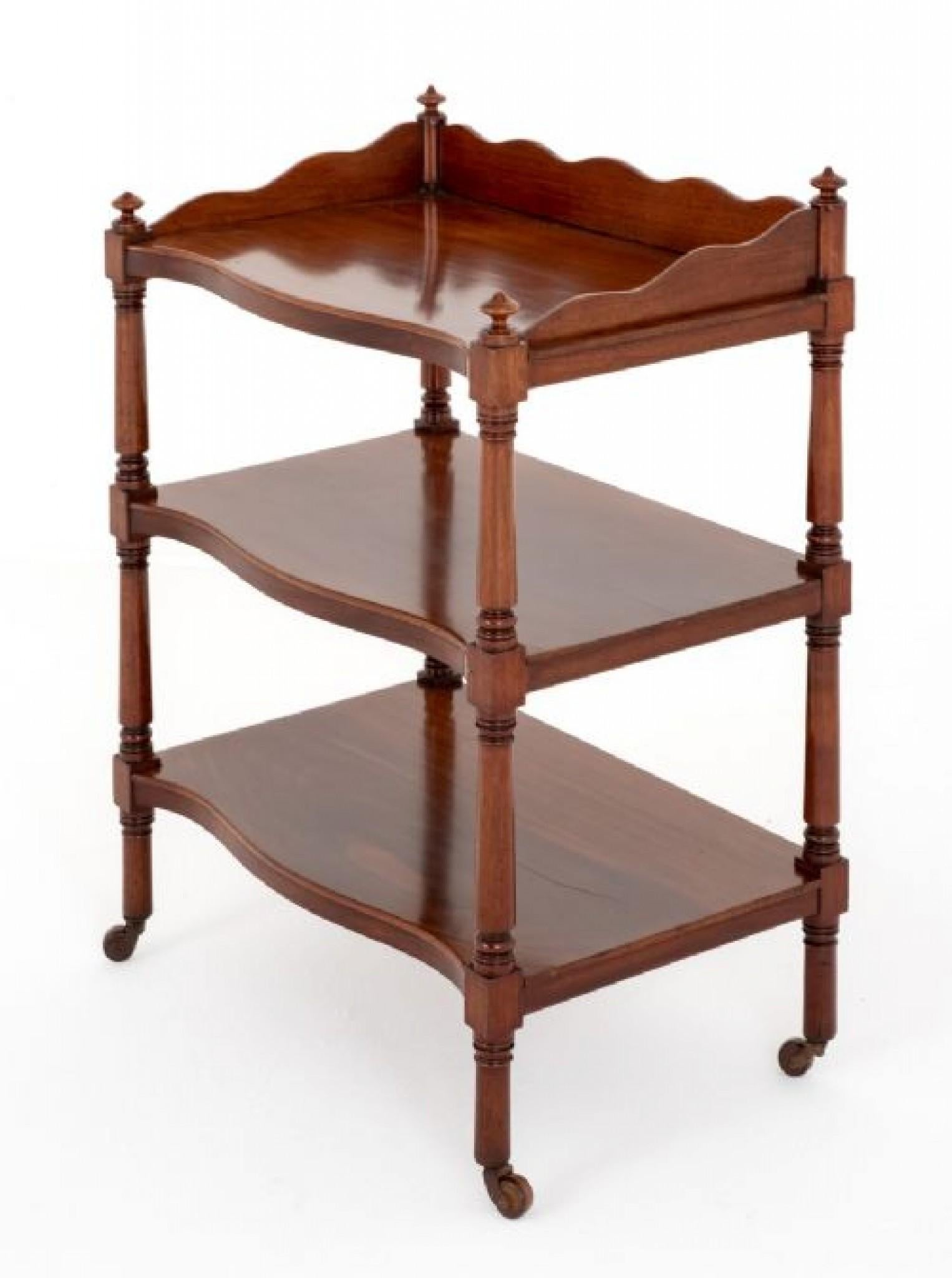 Early Victorian Mahogany What Not.
This What Not Stands Upon Brass and Porcelain Castors.
The What Not Features Turned Upright and a Shaped Upstand to the Top.
Having 3 Shelves of Serpentine Form.
Presented in Good Condition.
