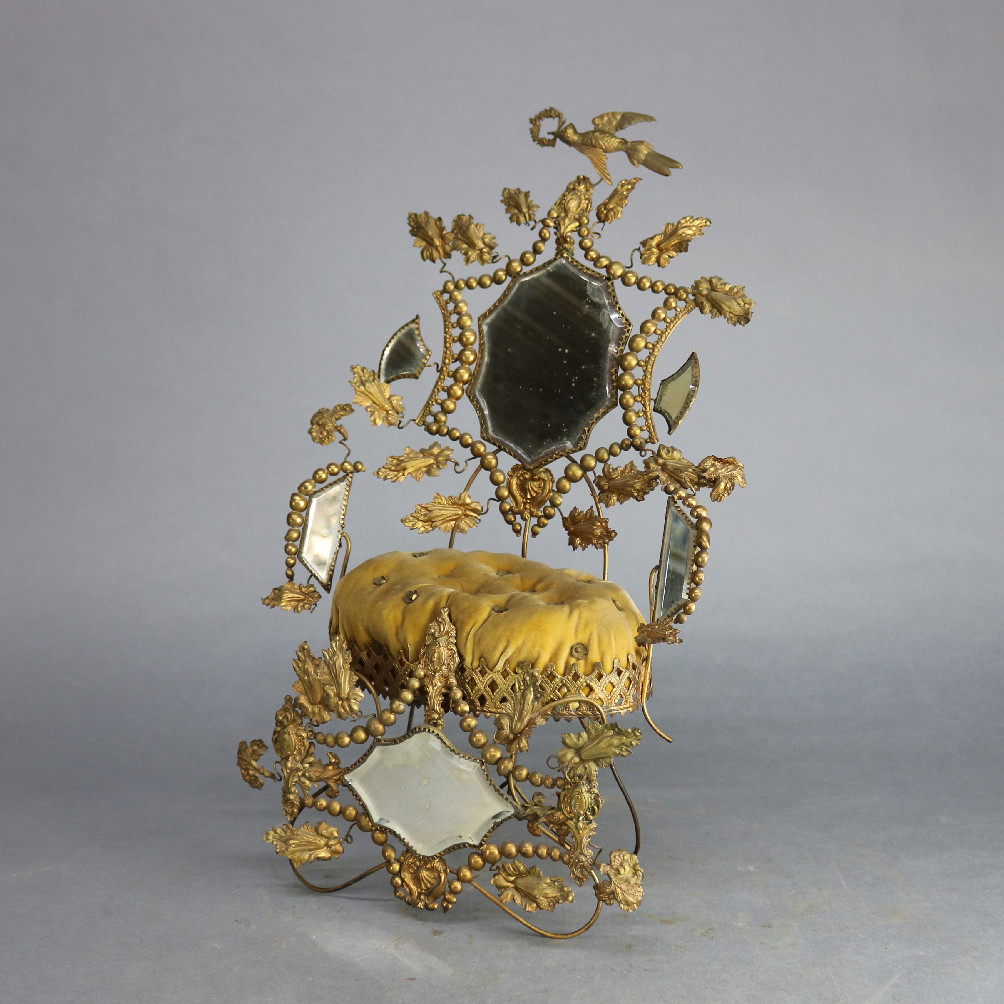 An antique Victorian whimsical miniature throne pin cushion settee offers gilt brass frame with central mirror and button cushion, circa 1880.

Measures: 21