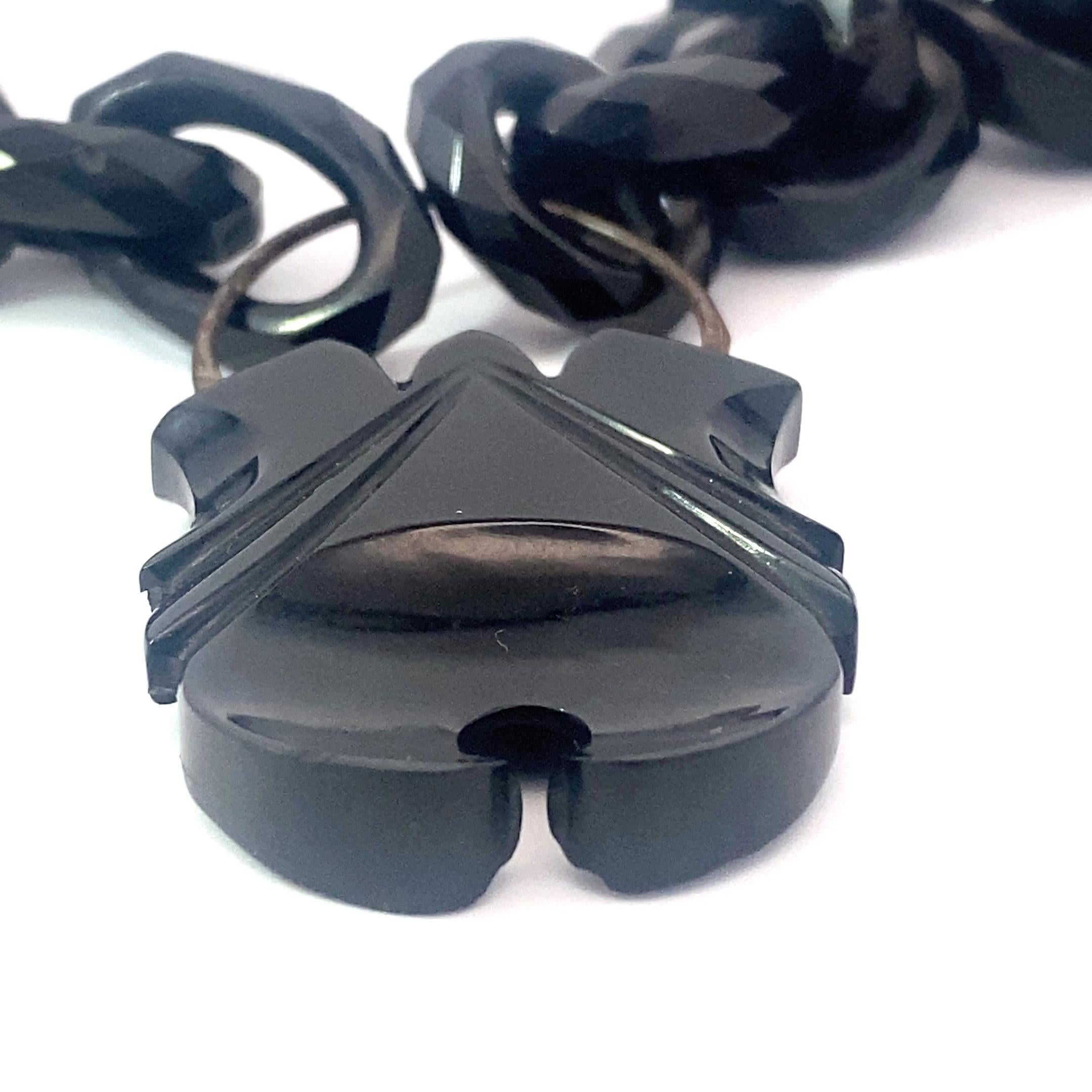 incredible whitby jet link chain with carved whitby jet padlock. this carved chain boasts approximately 24 inches of hand carved and light-weight links. Since each link is carved and assembled by hand, they are all a bit different, making them