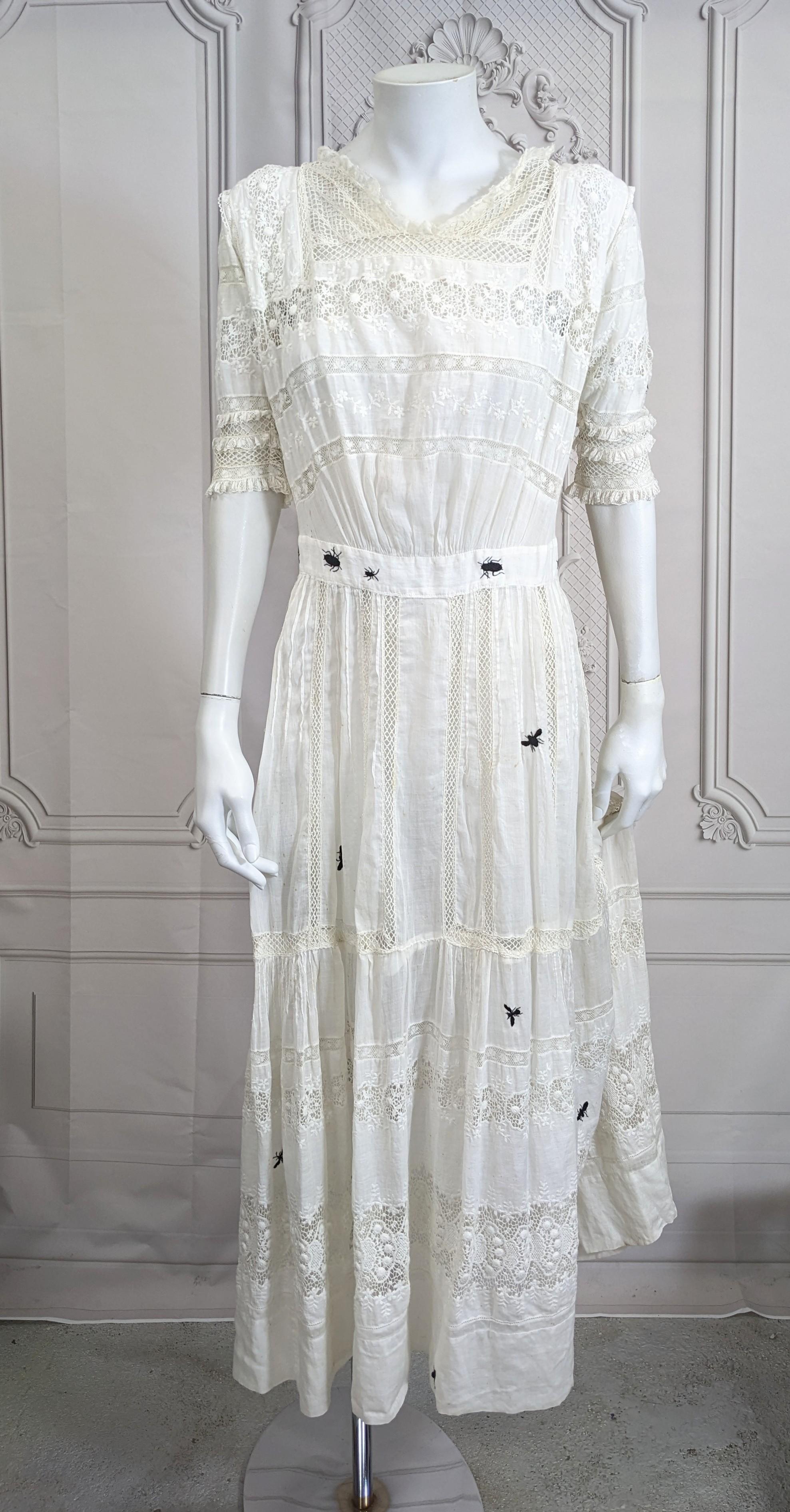 Victorian White Embroidered Dress, Upcycled Studio VL. One of a kind 19th Century cotton batiste dress inserted with different types of lace and then hand re-embroidered with creepy black insects of every variety throughout. Adorned with lace