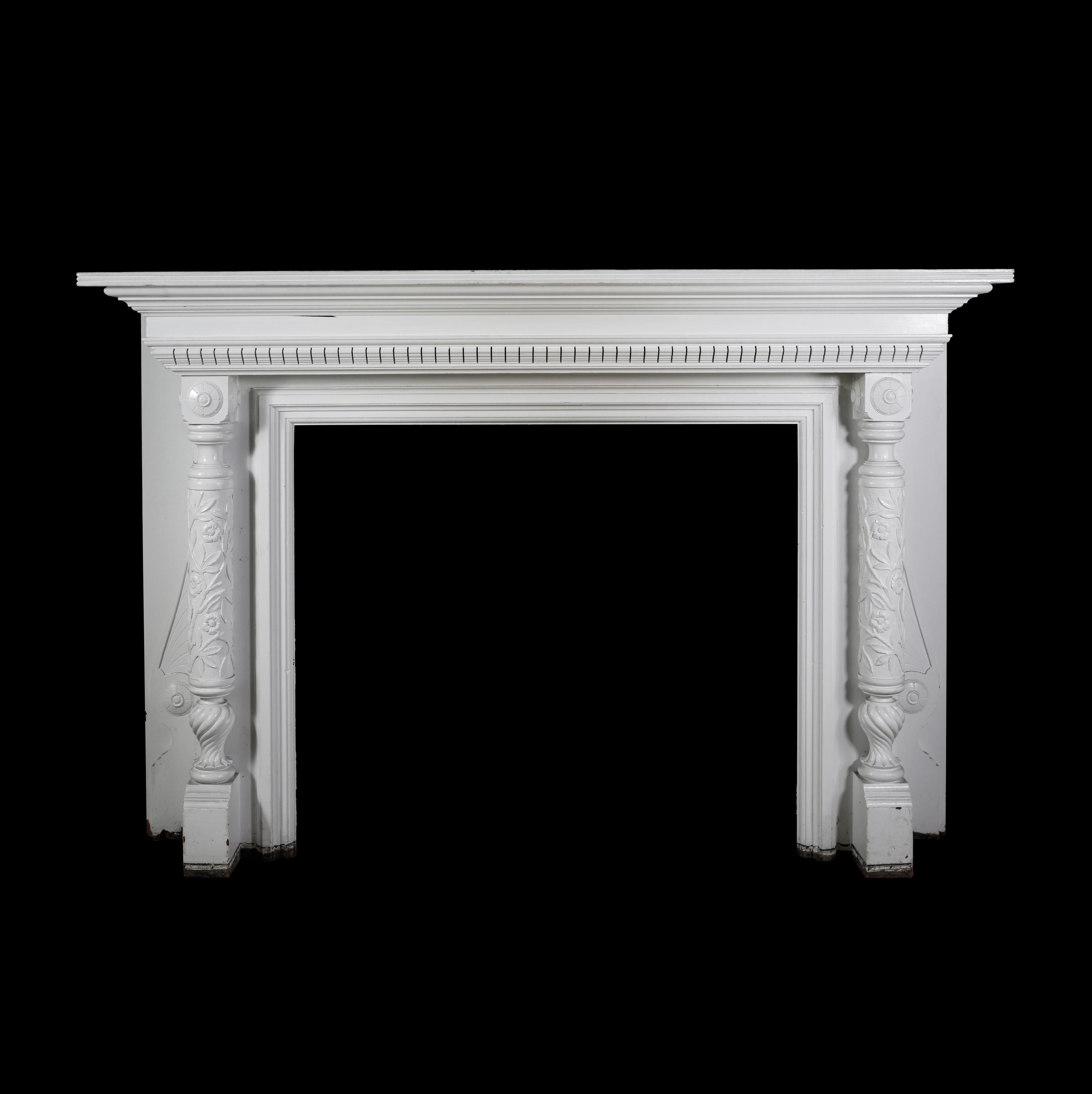 Victorian white painted solid wood mantel with dentil shelf crown molding and floral foliate carvings on the plinths. There is a repair on the back left of the shelf. Please note, this item is located in our Scranton, PA location