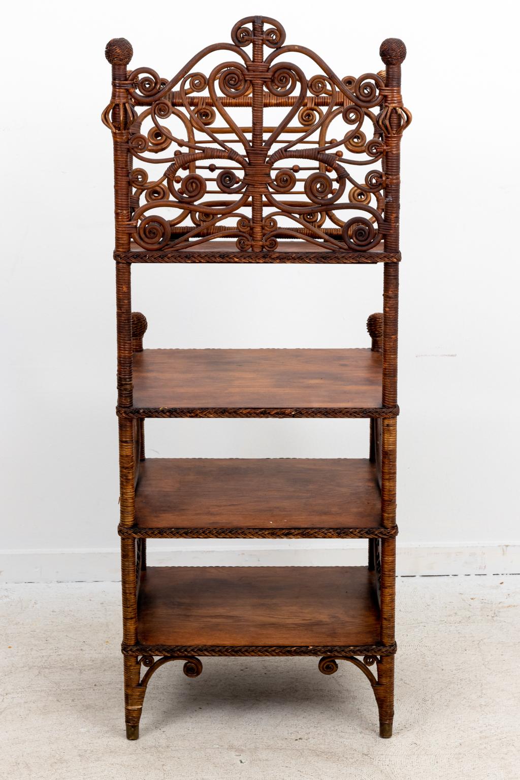 Circa 20th century Victorian style wicker woven music stand for sheet music. The piece also features scrolled detail on the top shelf and turned spindle work panels on the base. Please note of wear consistent with age including minor finish loss.