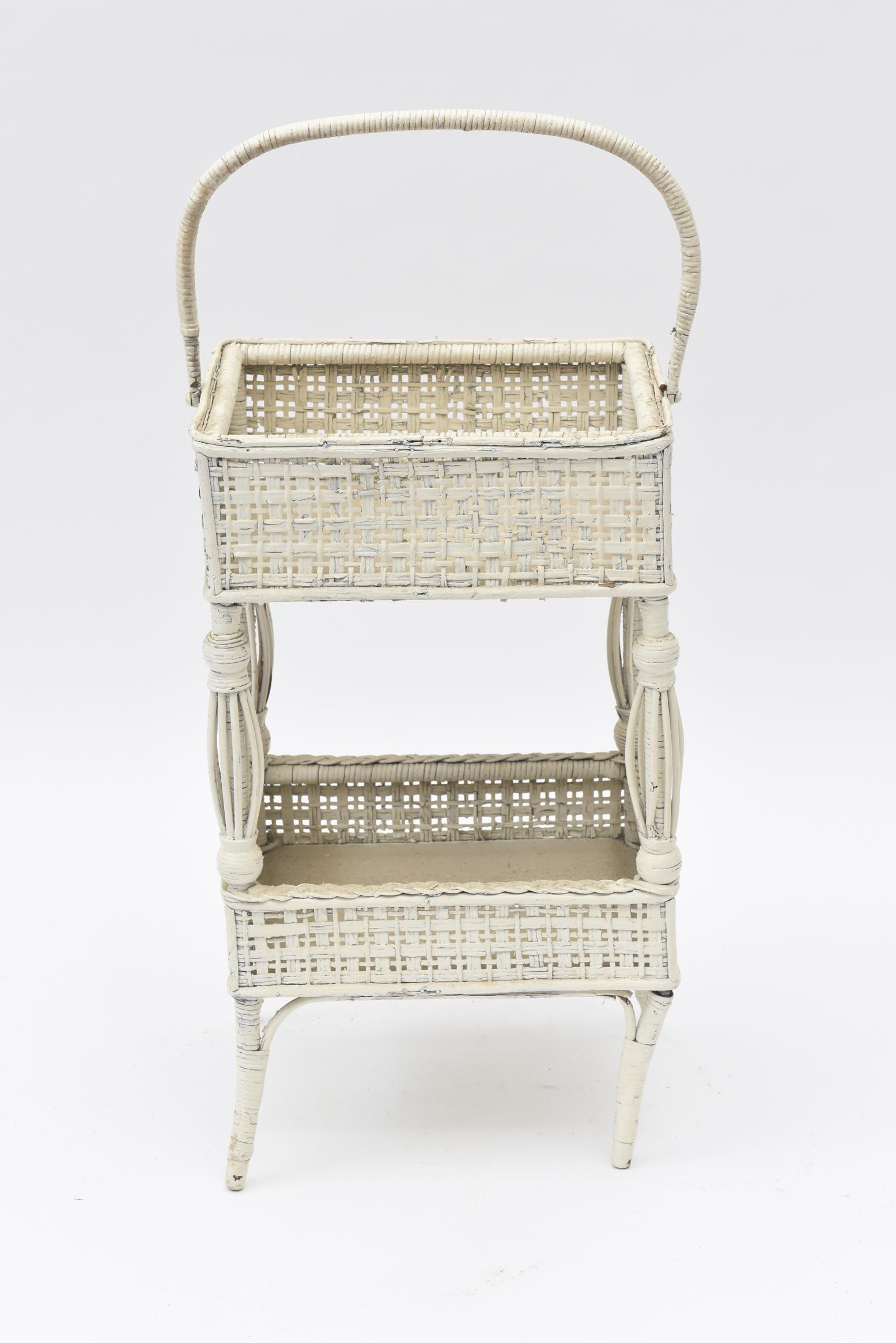 Birdcage legs typical of the late Victorian Era adorn this charming handled open sewing basket with its upper basket decorated with wicker loops on 3 of the 4 sides. The bottom basket is simple and can hold books, magazines or your current