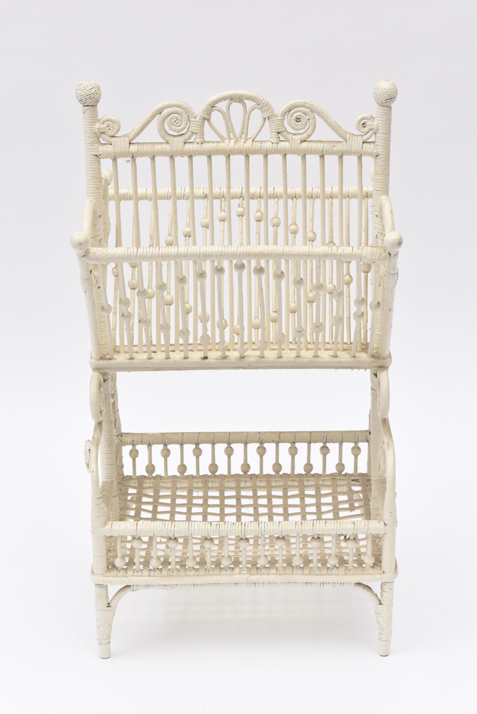Rare two tier beaded High Victorian Magazine rack with curlicues, pinwheel sides and woven ball tops. The bottom of this exceptional piece is an open basket weave with bead and stick sides on all sides, the top two forming diamond shape beading