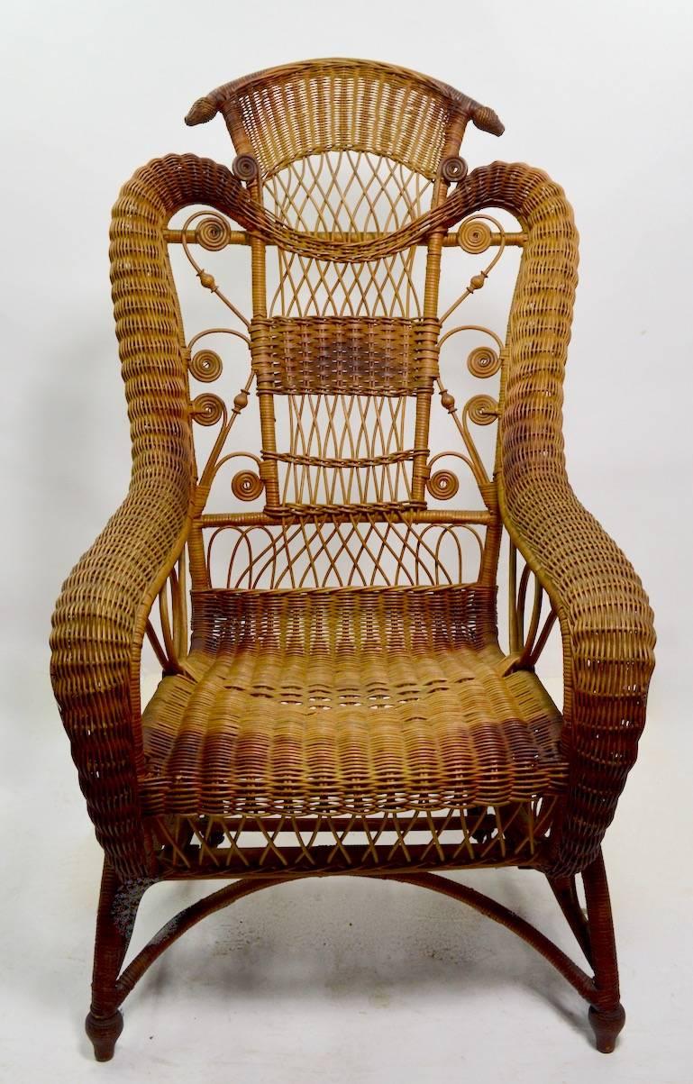Exquisite Victorian platform rocking chair, in original natural finish. Unusual to find these in unpainted, and undamaged condition. This example shows only some slight color variation to the finish, as shown. Rocking chair sits in stationary base,