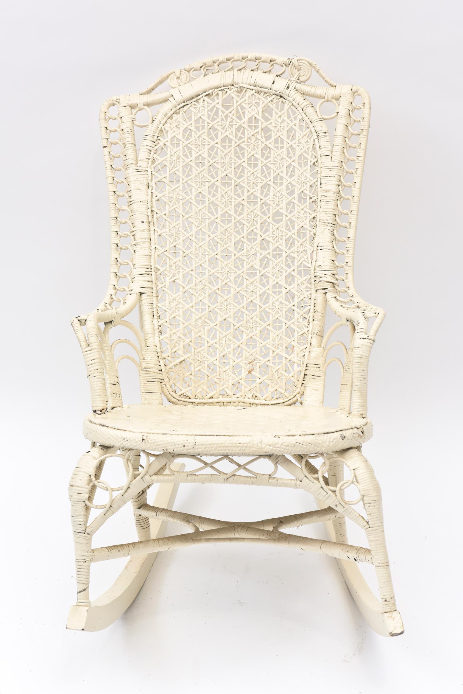 This Victorian ladies rocker matches the youth chair we have also listed. The arms and back are high Victorian style. It was probably a mother's nursery chair perhaps used for nursing her baby. The seat is leather and has been painted white. It is