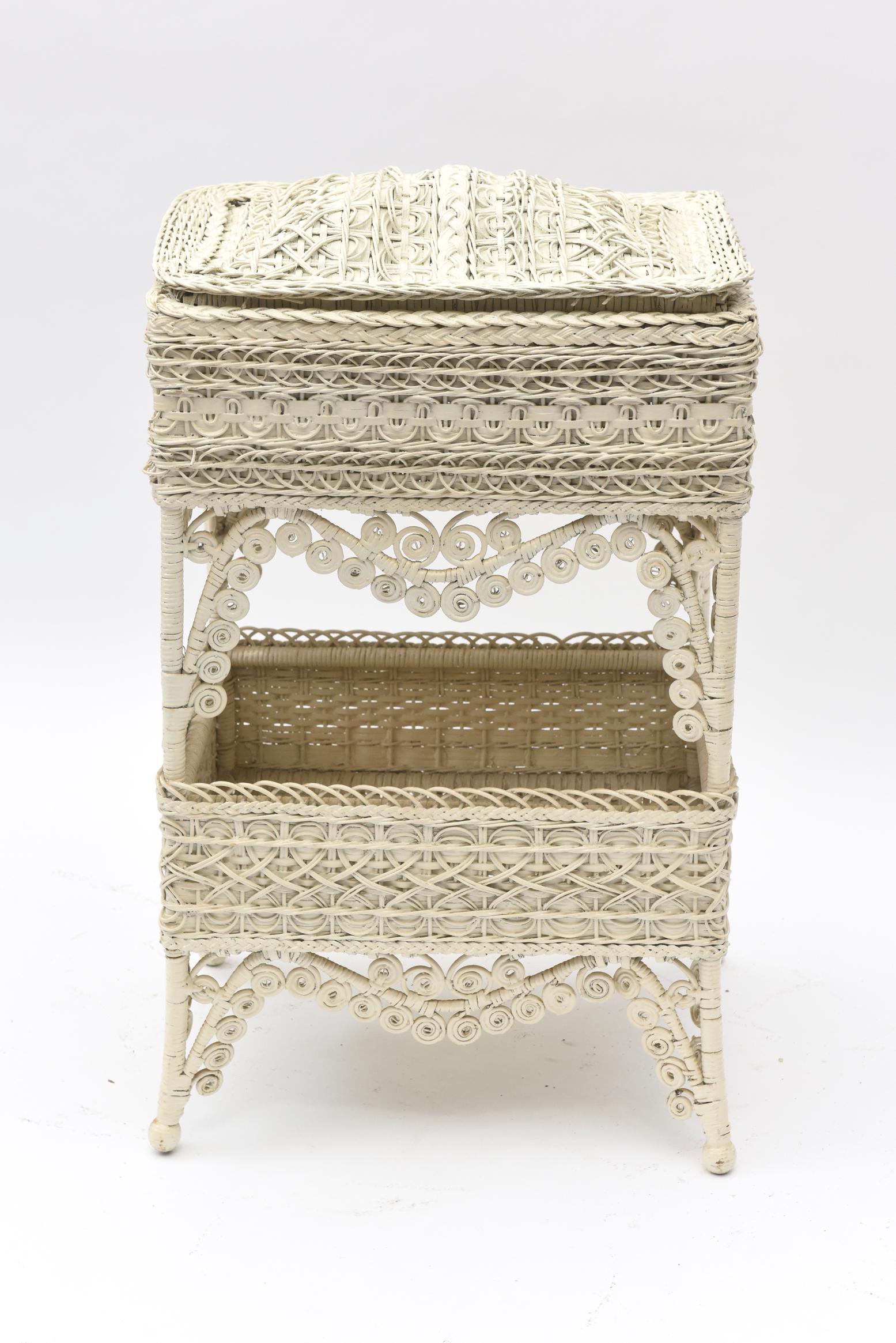 Part of a large collection of ornate Victorian wicker that was collected over the years by a Senator's wife. Rectangular in shape, this Victorian wicker sewing stand has a dome lid, ornate curlicue trim, an under basket for works in progress and