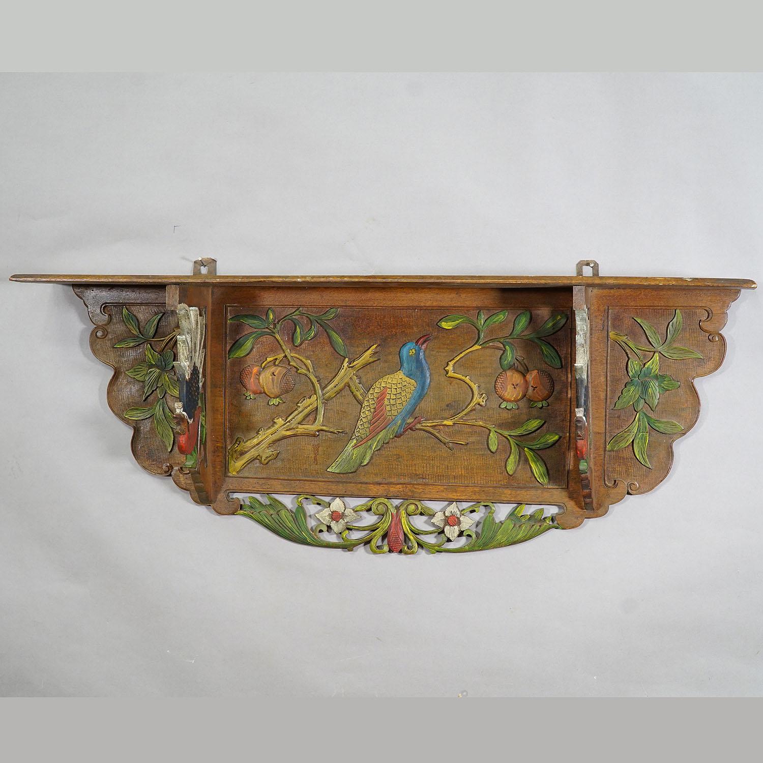 A great Victorian wooden shelve with detailed carvings depicting stylized foliage, fruits, flowers and birds. Hand carved and polychromic painted in Germany, circa 1920. Very good original condition and ready to hang-up.

Measures: Width 39.37