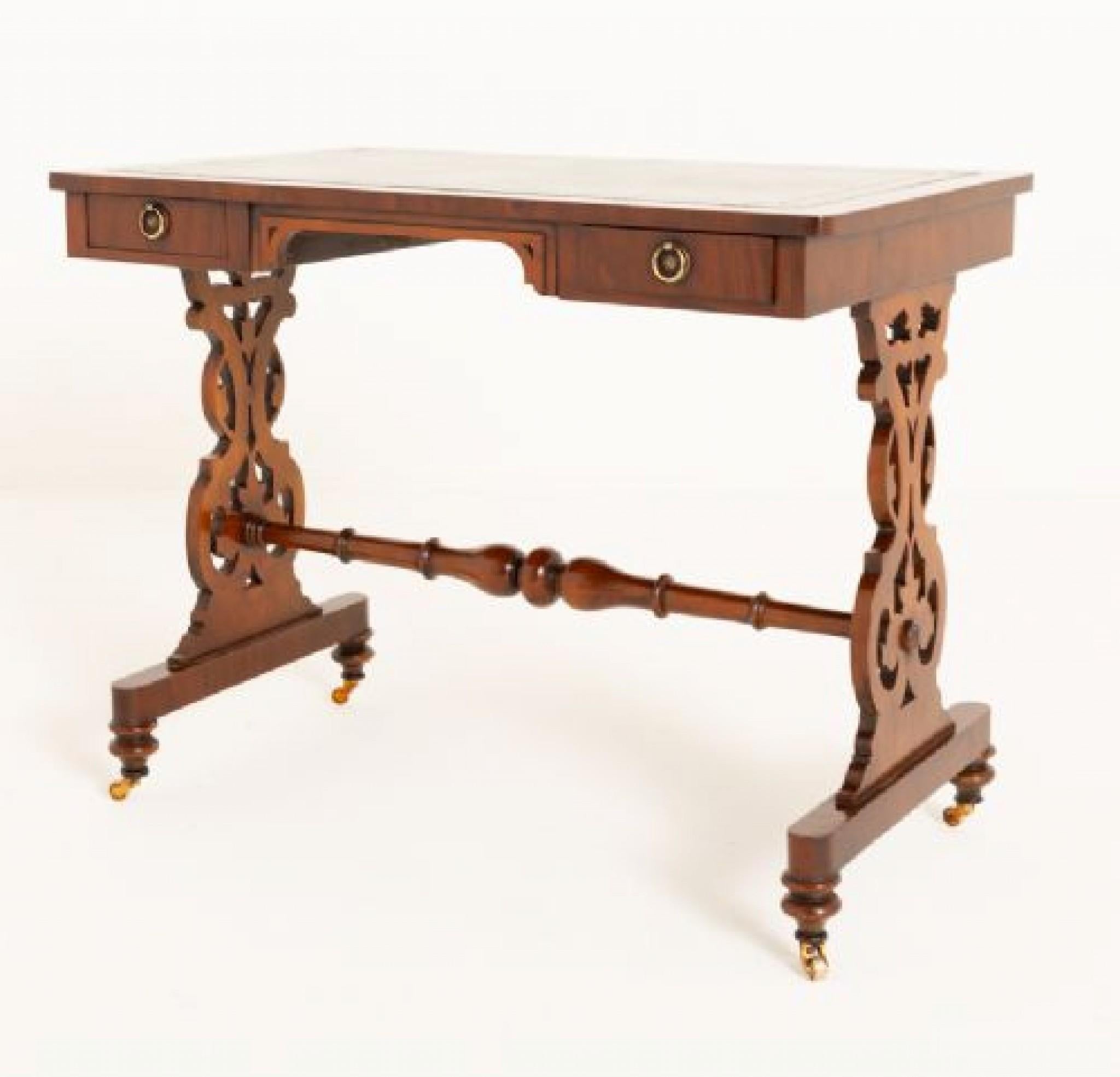 Victorian Mahogany Writing Table.
Circa 1860
This Writing Table Features Lyre End Supports, a Shaped Undershelf and Shaped Feet.
The Top of the Writing Table Having 2 Oak Lined Cushion Styled Drawers and A Fitted Green Leather Writing Surface