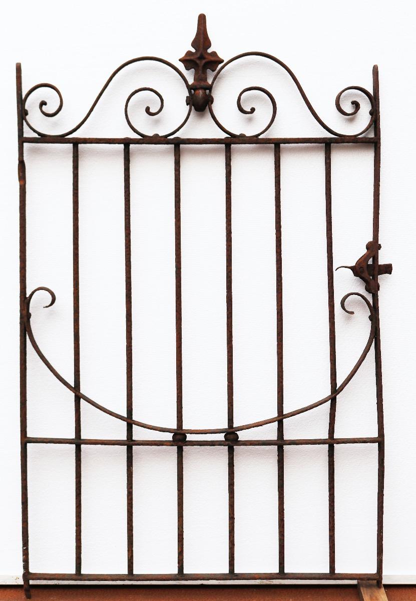 A reclaimed Victorian wrought iron gate with a decorative finial on the top and working latch.