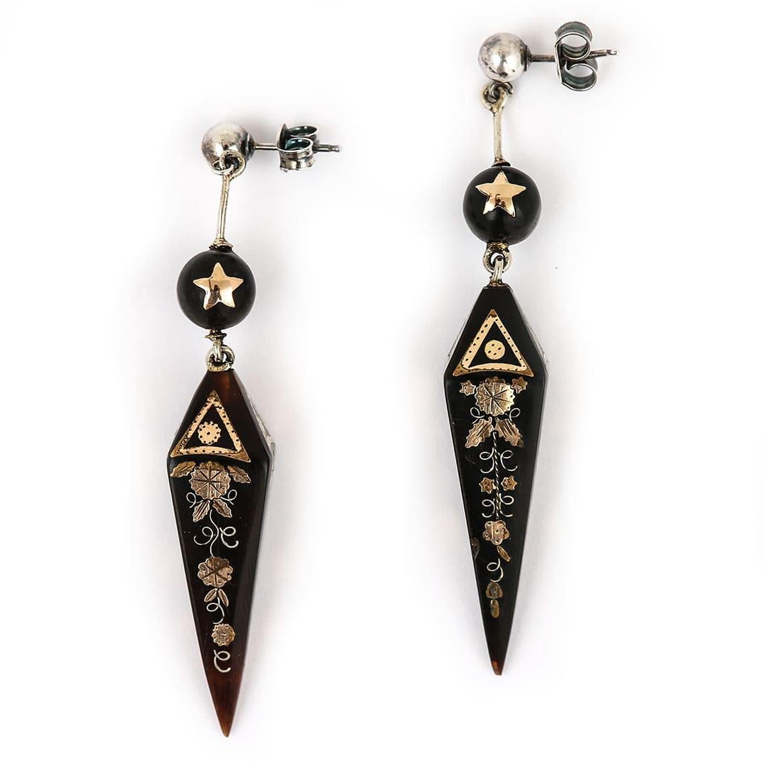 A delightful pair of Victorian yellow gold and silver inlay pique earrings hand crafted in circa 1870. The tapered obelisk shaped pique drops, beautifully inlaid with stylised floral and fine like motifs motifs along with geometric patterns and