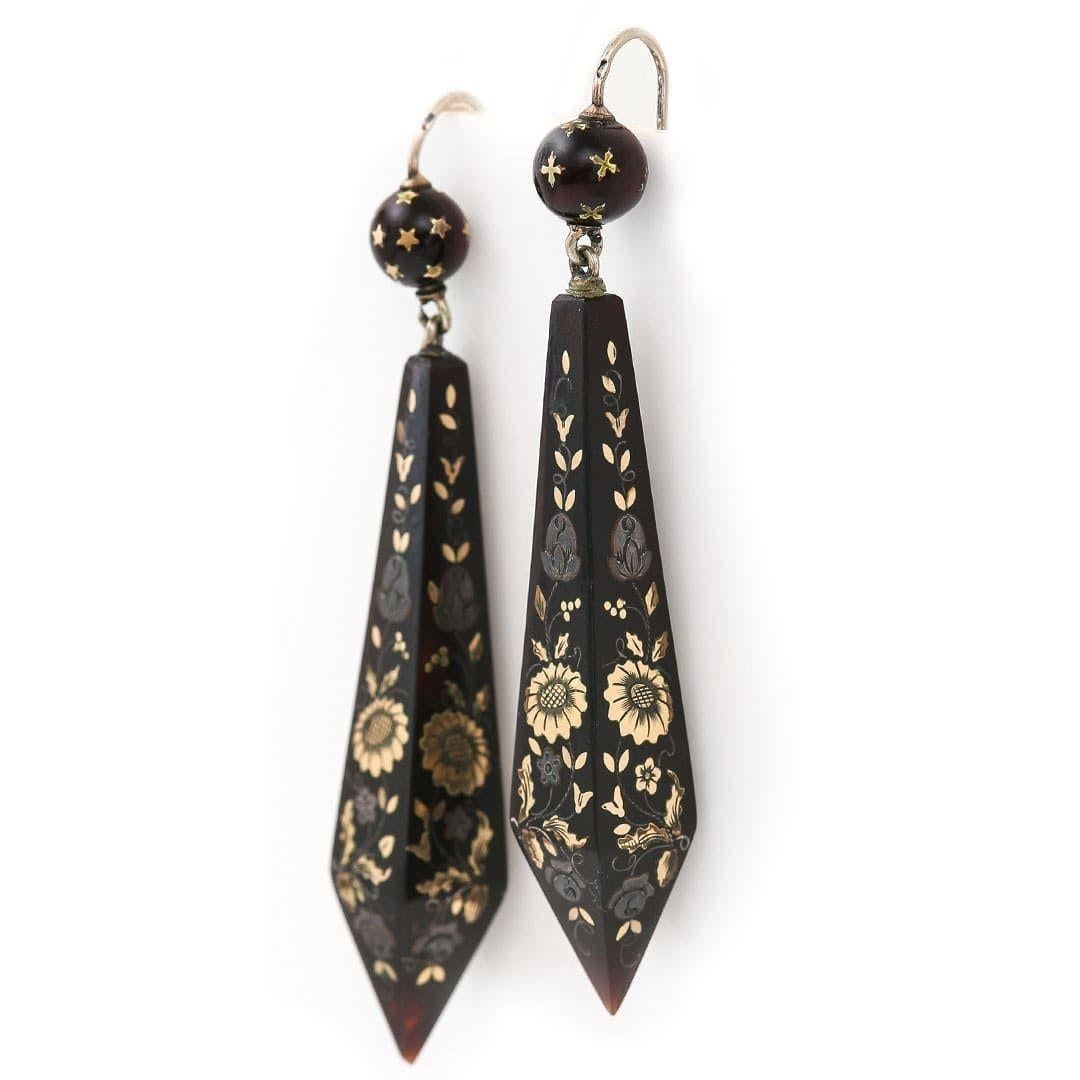 A stunning pair of Victorian yellow gold and silver inlay pique earrings hand crafted in circa 1870. The obelisk shaped drop earrings, beautifully inlaid with stylised floral motifs, geometric patterns and tendrils. Still maintaining their original