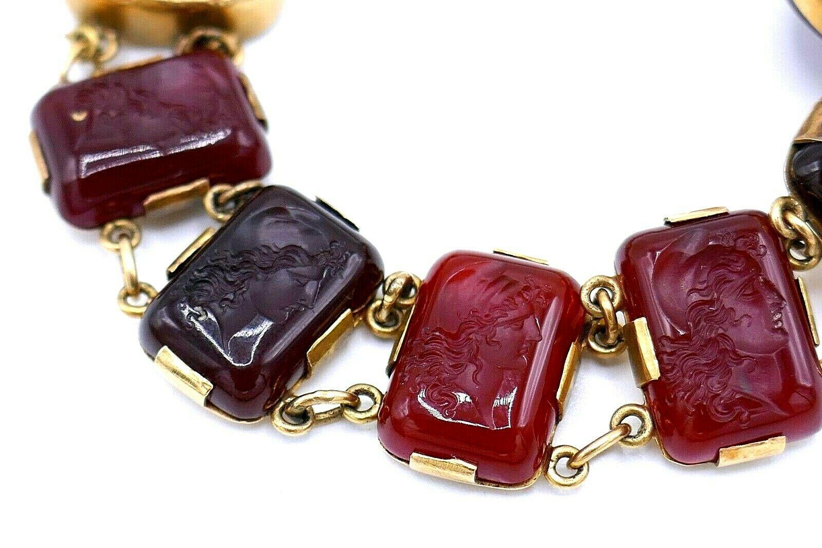 Victorian carved carnelian cameo bracelet with ten rectangular cameos depicting classical female profiles. The central carnelian is a spinner: one side is a scarab, another has a carved figure of a hunter/warrior. Setting is made of 14k yellow gold