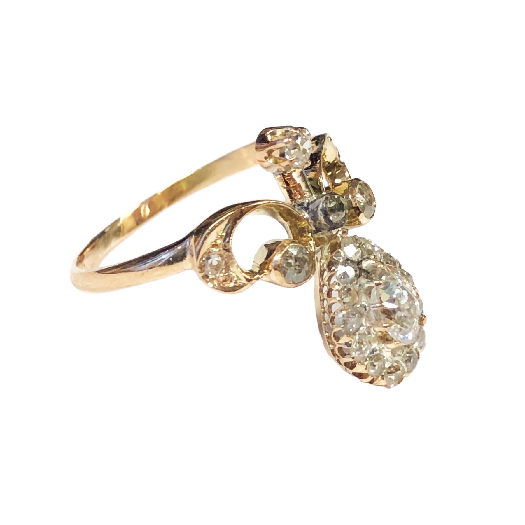 Circa 1890s Yellow Gold Tiara Ring, measuring 3/4 inch in length and centrally set with an old mine cut pear shape Diamond approximately 1/3 carat and further set with numerous old cut Diamonds totaling 1/2 carat. Finger size 8 1/2
