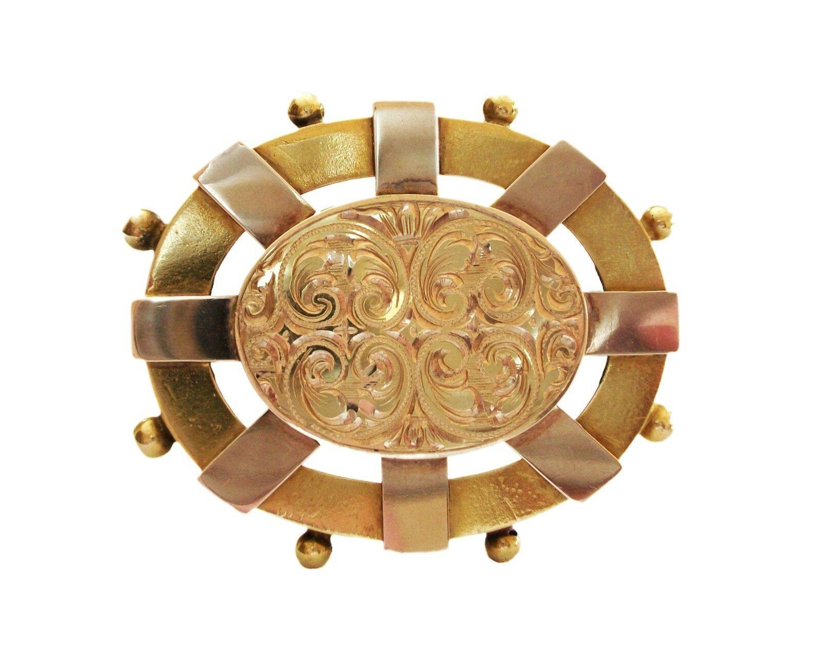 Victorian yellow gold Etruscan Revival brooch with locket to the back - fine and elaborate engraved gold scroll pattern to the front panel - hand made featuring gold balls to the rim - numerous auction house/jeweler notations to the back (one