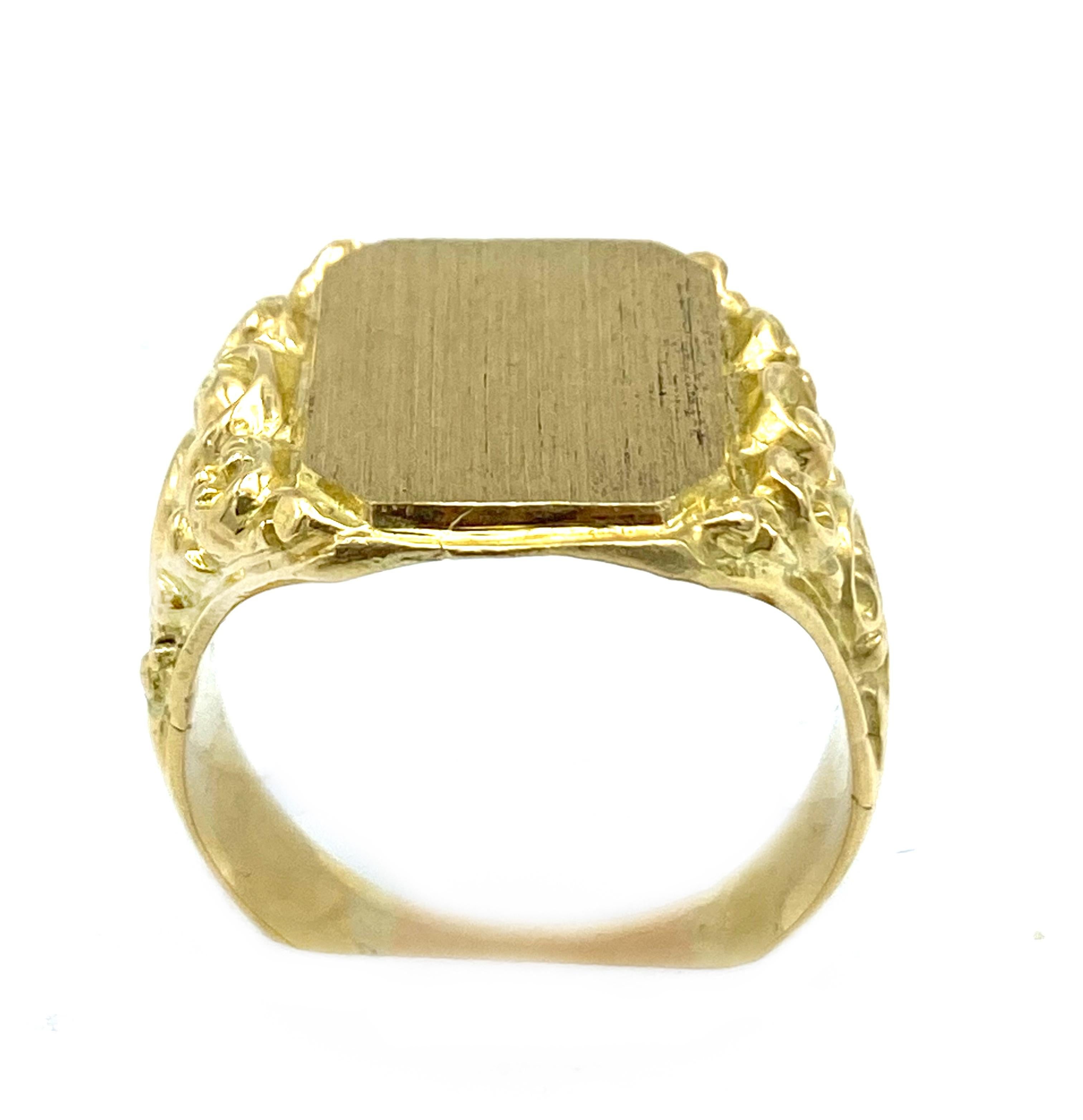 Product details:

The ring is made out of 14 karat yellow gold, featuring plain front and floral motif on the sides.

Total weight is 20.0 grams. 
Measurements: 1- 1/16