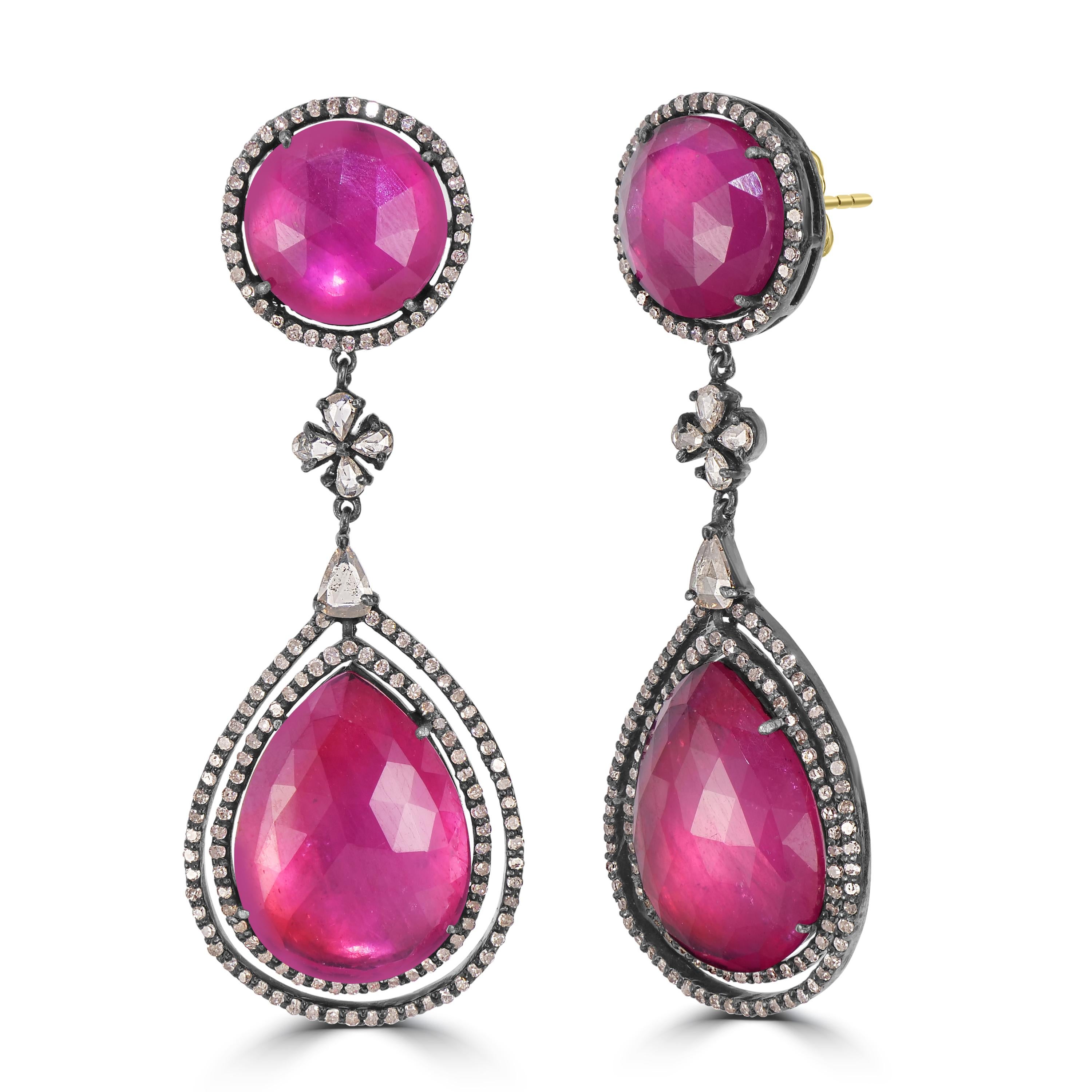 Embark on a journey into the resplendent world of Victorian glamour with our Victorian 39.62 Cttw. Ruby and Diamond Dangle Earrings, a symphony of regal design and exquisite craftsmanship. These earrings are a masterpiece of elegance, featuring a