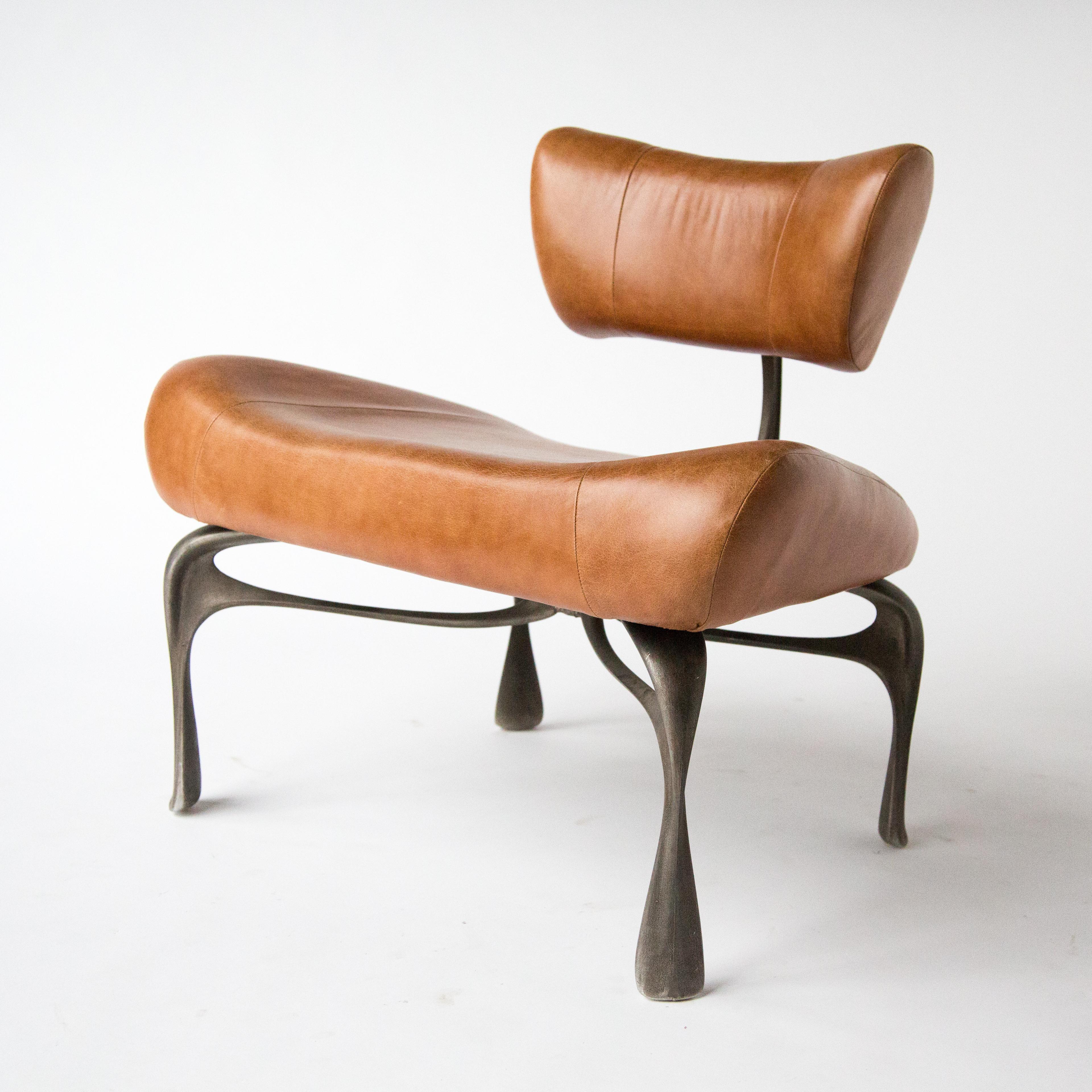 Jordan Mozer, Victory lounge chair, leather and cast, recycled magnesium-aluminum alloy with hand rubbed patina, made in Chicago, 2012/2019. A 2019 variation on the lounge chairs created for Victory at the Meadowlands in 2012-13. It is about 31”