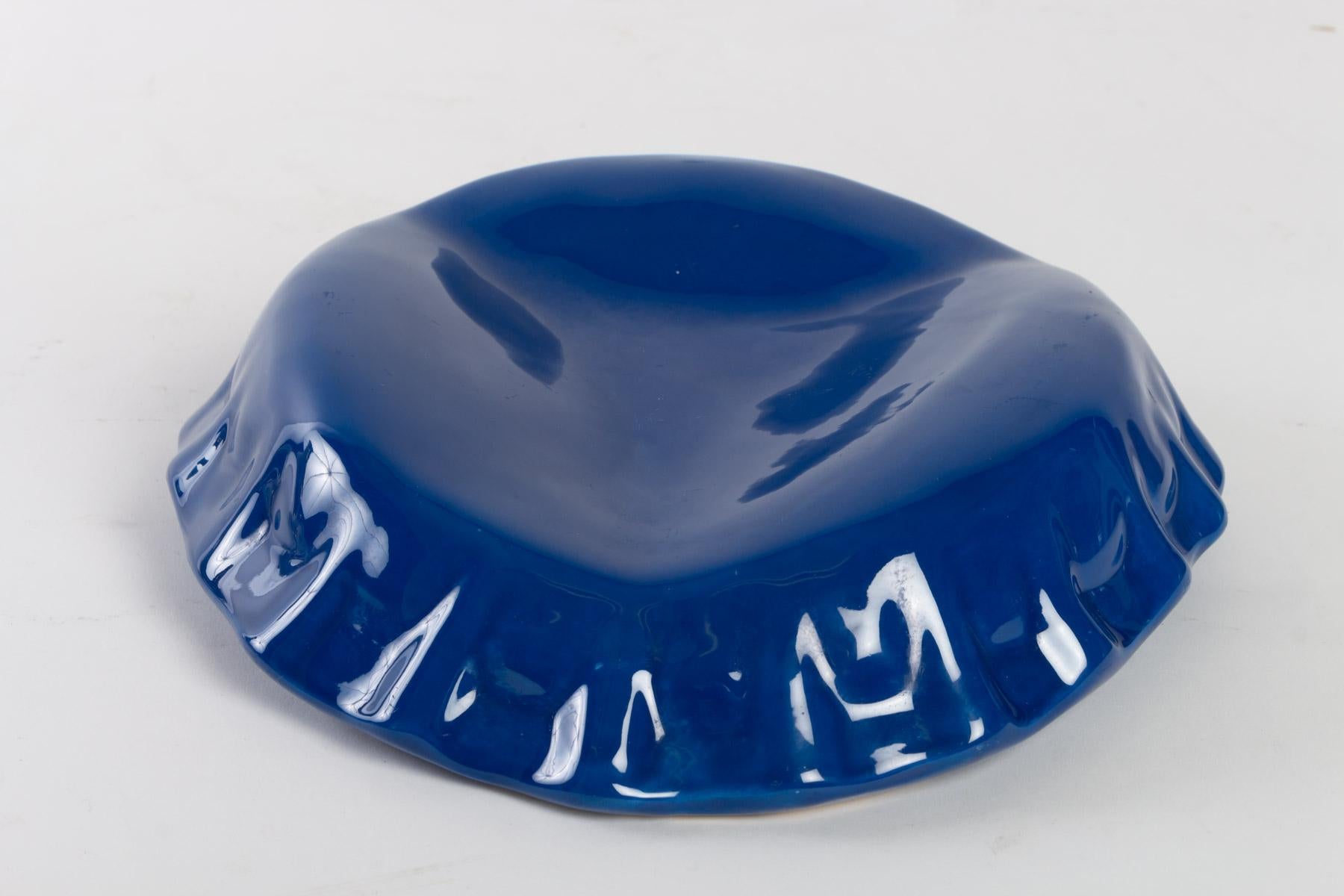 Videopoche in Form einer Can Cap, blau emailliertes Porzellan, 20. Jahrhundert.
Maße: D 27 cm, H 7 cm.