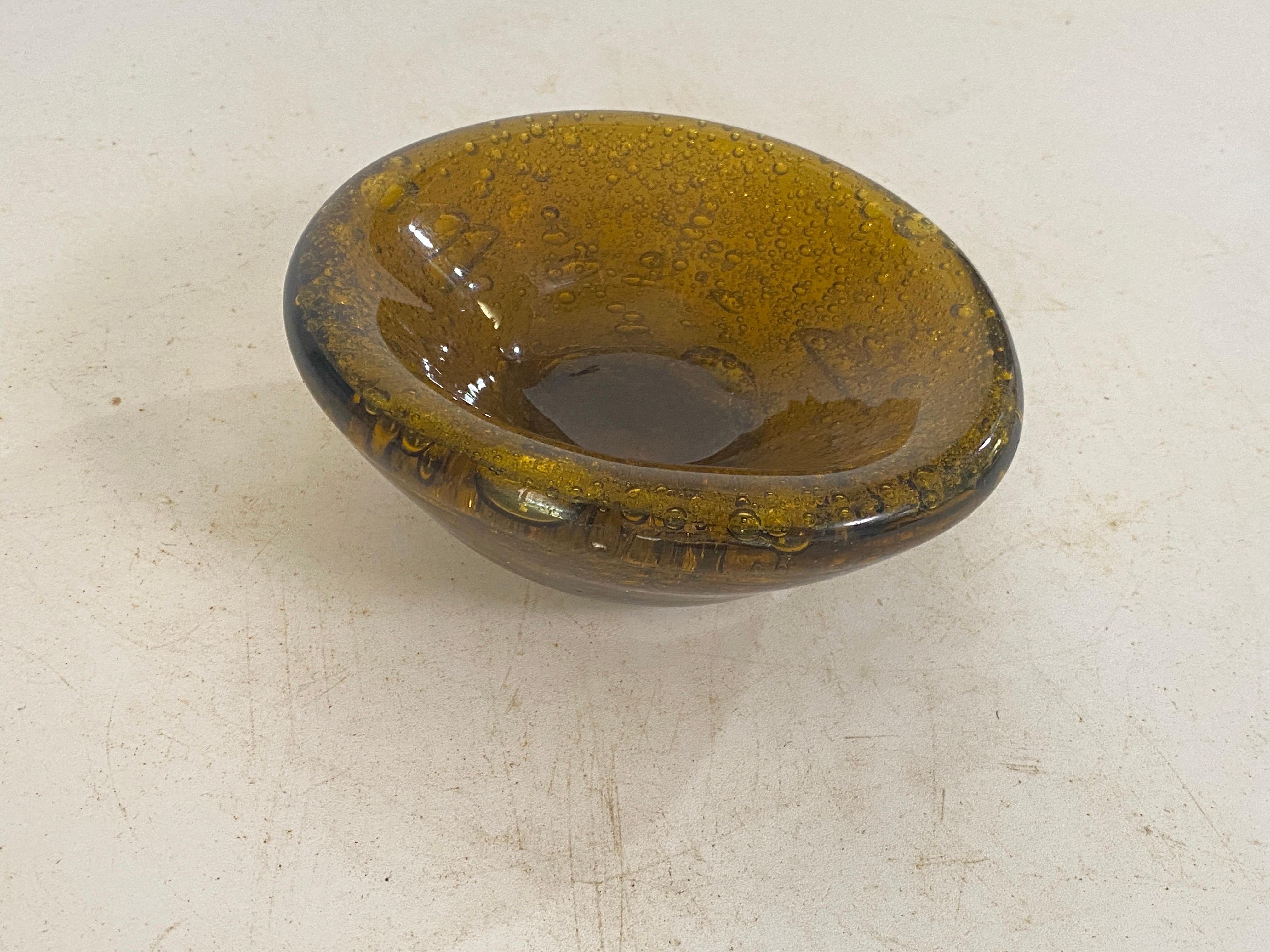 This vide poche or ashtray in in Glass. It has been done circa 1970, in France.
It has been made  in Biot.
Transparent yellow Color.