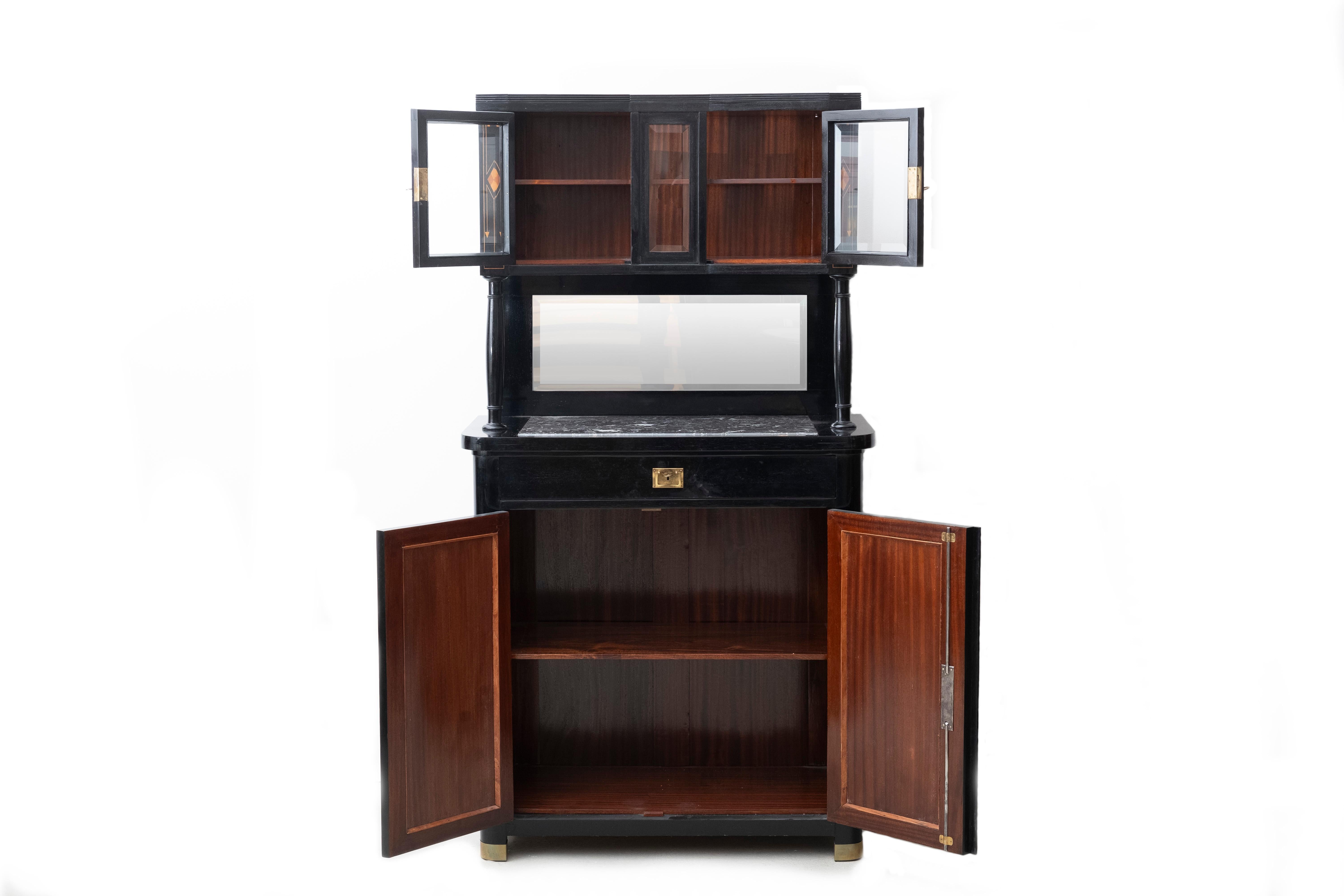 Secessionist Cabinet / Buffet
Vienna, Austria, circa 1900
This cabinet features:
- wooden intarsia (fruit wood)
- a rectangular inlayed marble plate and a vertically placed mirror with facetted corners
- polished brass fittings key hole fittings and