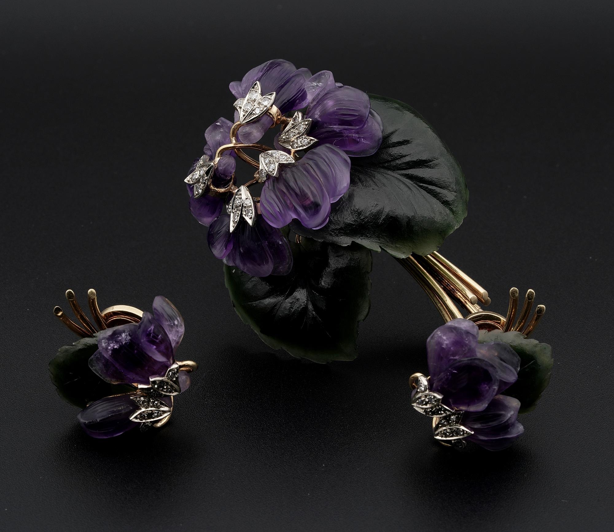 Nature Inspired

An Amethyst Nephrite and Diamond brooch and clip earrings suite in 18 KT yellow and white gold , bearing Austrian marks Vienna from the 1950s.
Brooch depicting wild Violet beautifully hand carved arranged as a bunch with rich