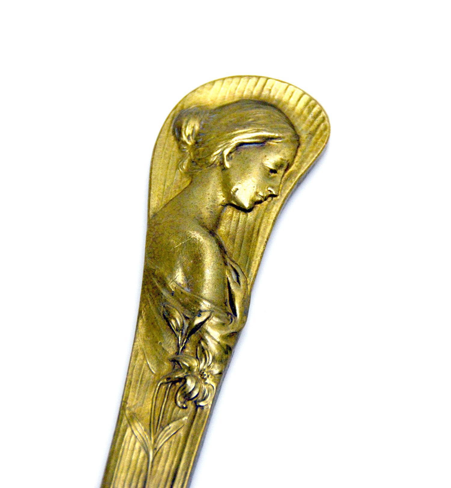 Art Nouveau lady figure bronze letter opener

Here is a Art Nouveau bronze letter opener. Front of handle depicts a Nouvea Woman Disrobing, and on the reverse there are cosmos Flowers. The entire opener is worked and extremely detailed. Signed on