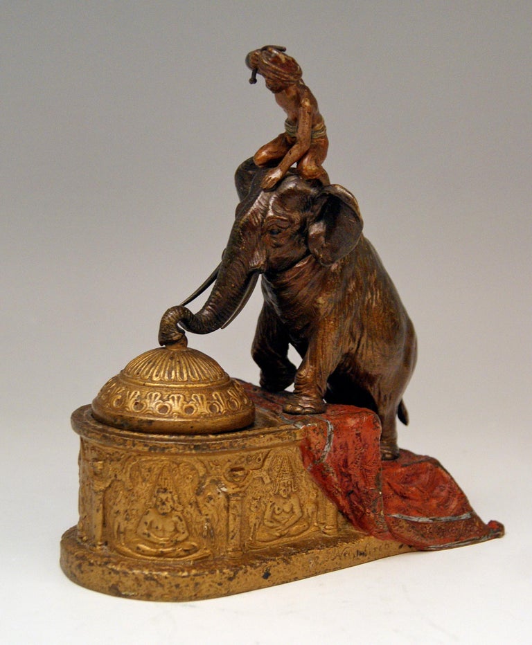 Stunning bronze item which has function of an inkpot, inkstand, inkwell, Indian man is situated on elephant which is climbing up some stairs, the elephant's trunk is attached to an inkstand's lid, the animal's head is movable so that the lid can be