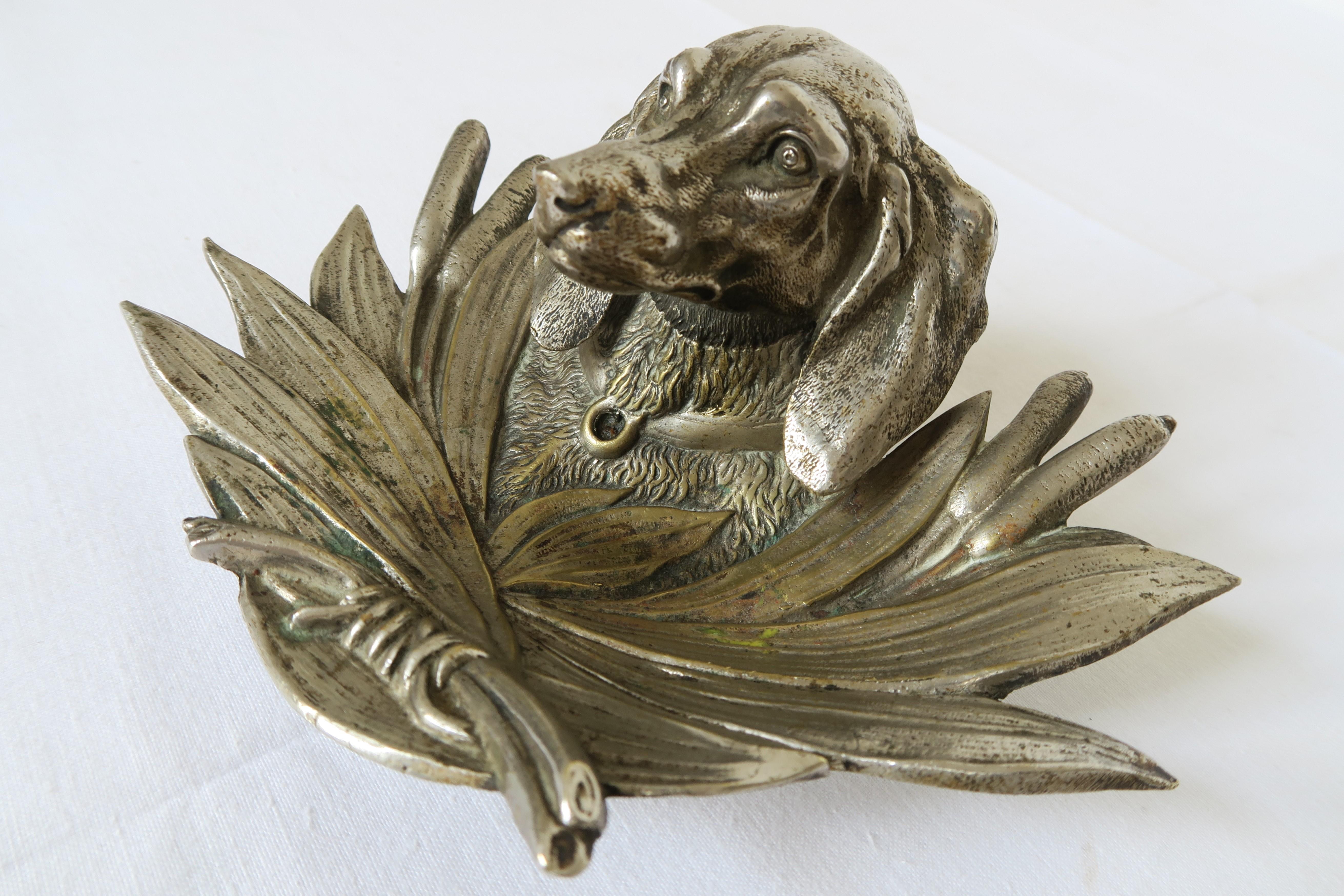 Fore sale is a hunting motive inkwell. It is shaped like the head of a dachshund surrounded by reed. It was professionally crafted around 1900 and made from Vienna Bronze and chrome plated. The material still has its original shine and is undamaged.