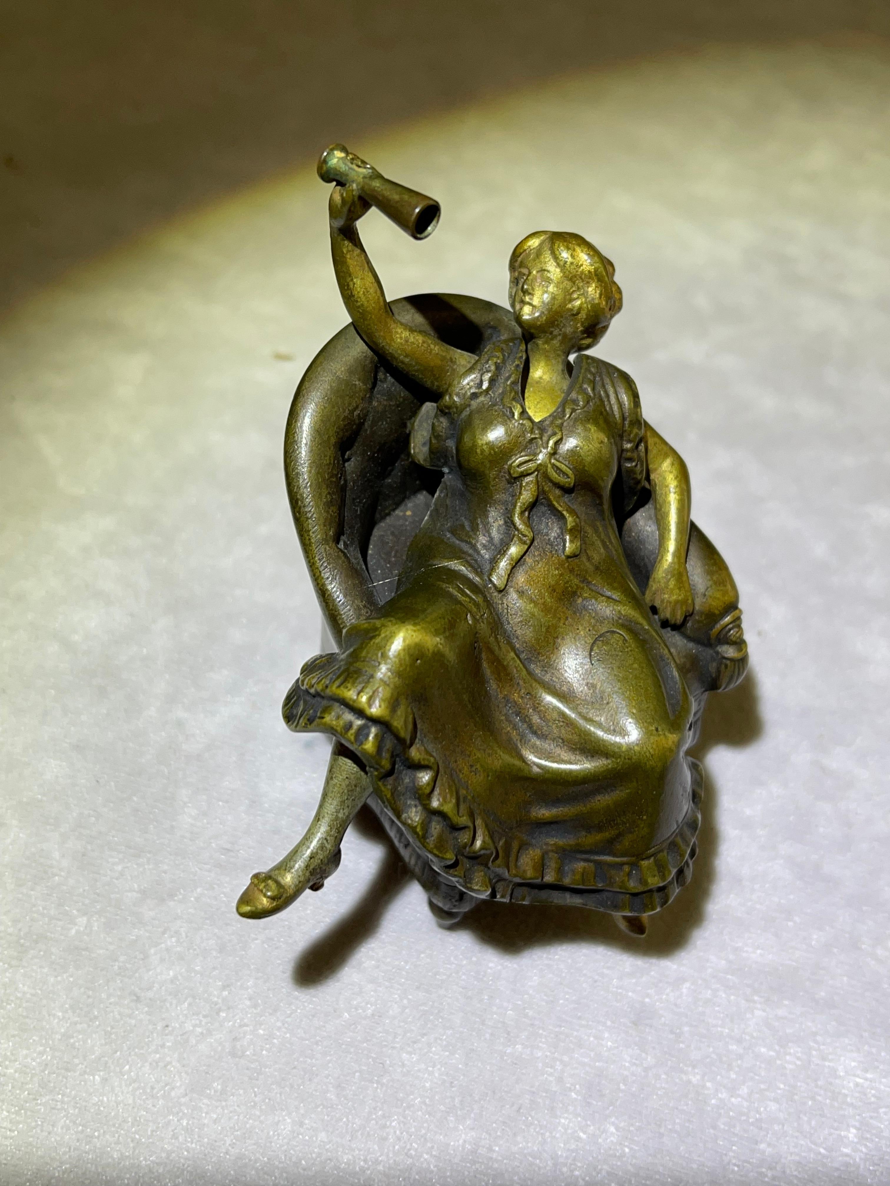 This delightful little bronze depicts a sexy girl in a chair holding a wine goblet, but the fun starts when you remove her bronze skirt. Very nice detailing everywhere to include the attention paid to the quality of the chair. It has all the