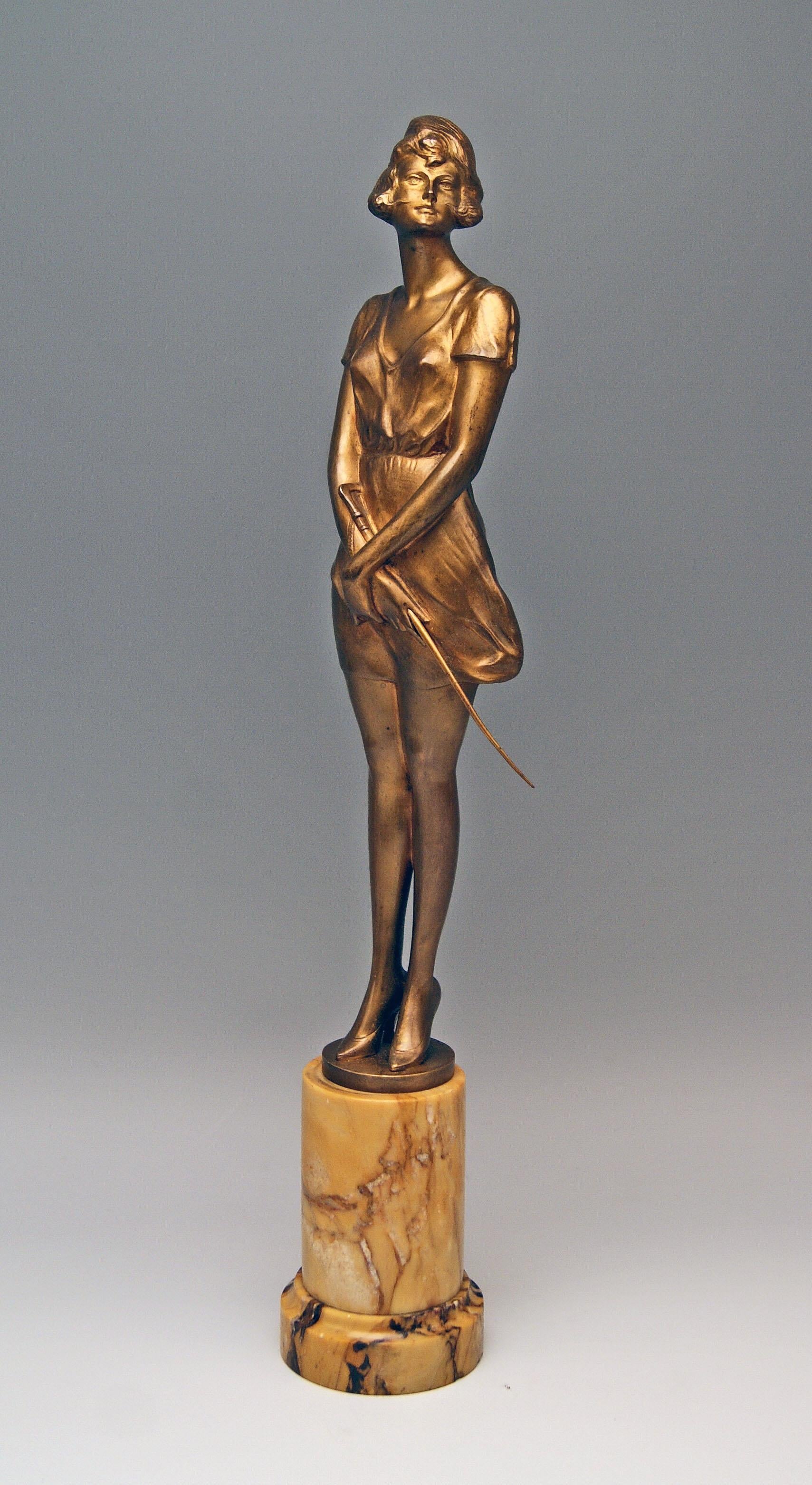 Interesting bronze figurine: Lady holding a riding crop

 It is a finest Viennese bronze item: The lady in high heels stands on round flat bronze base which is attached to marble column. The woman holds a riding crop in both hands which are