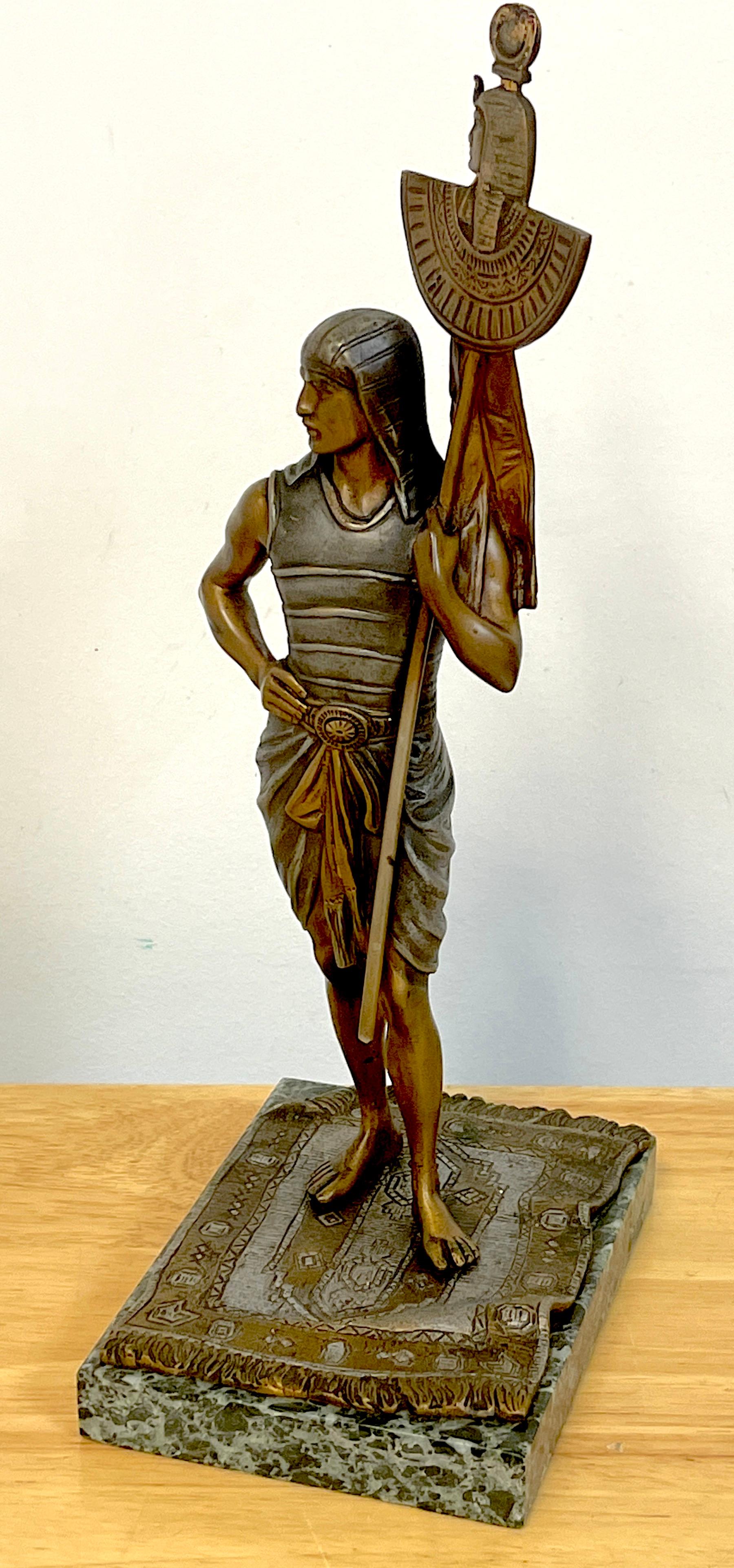 Vienna cold painted bronze Egyptian attendant, attributed to Bergman
With exquisite detail the standing Egyptian attendant standing on a Persian rug holding a ceremonial staff.
Apparently unsigned. Raised on a verdigris marble base measures 4.25